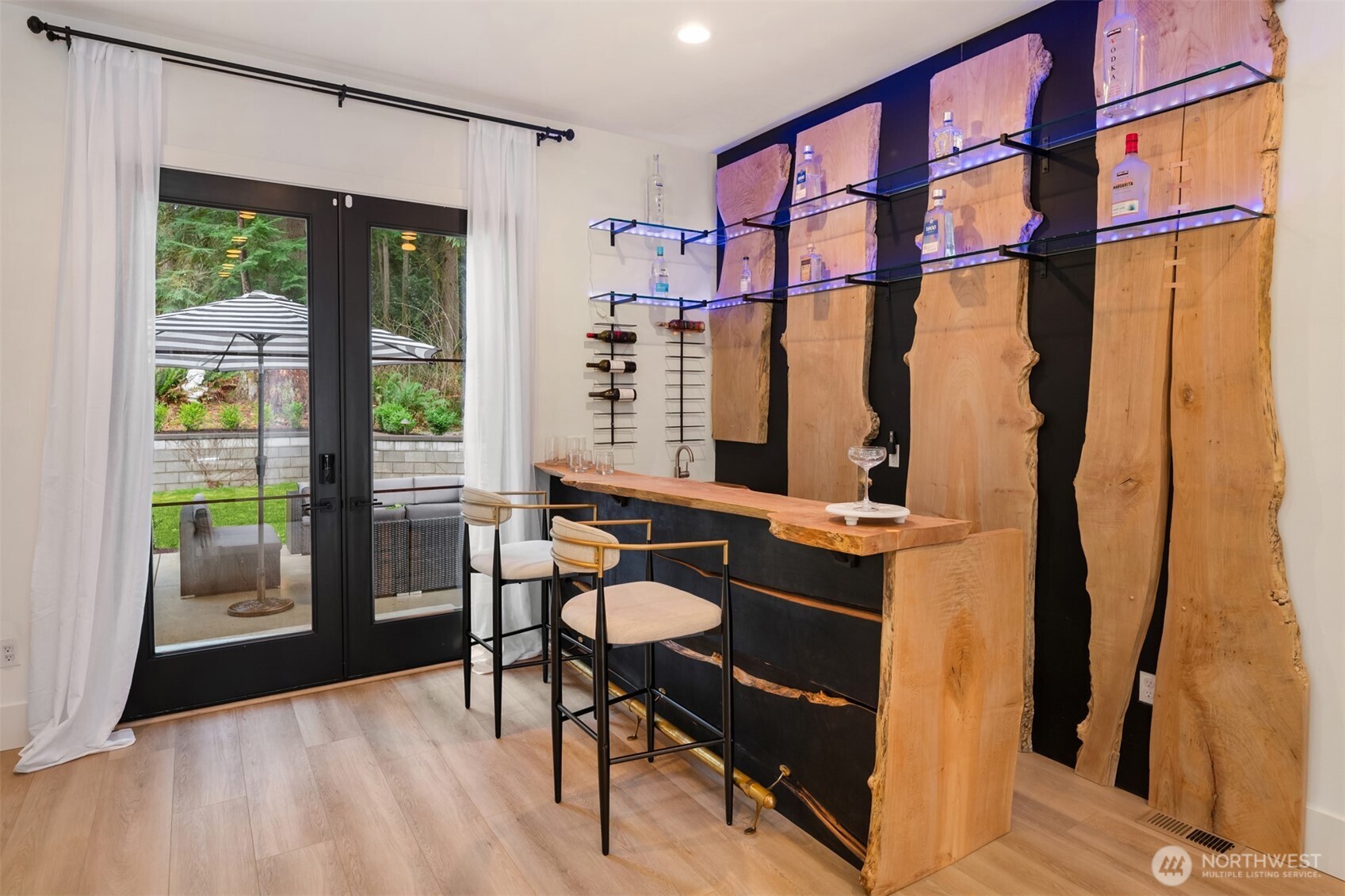 Custom bar crafted from wood slabs salvaged from the property