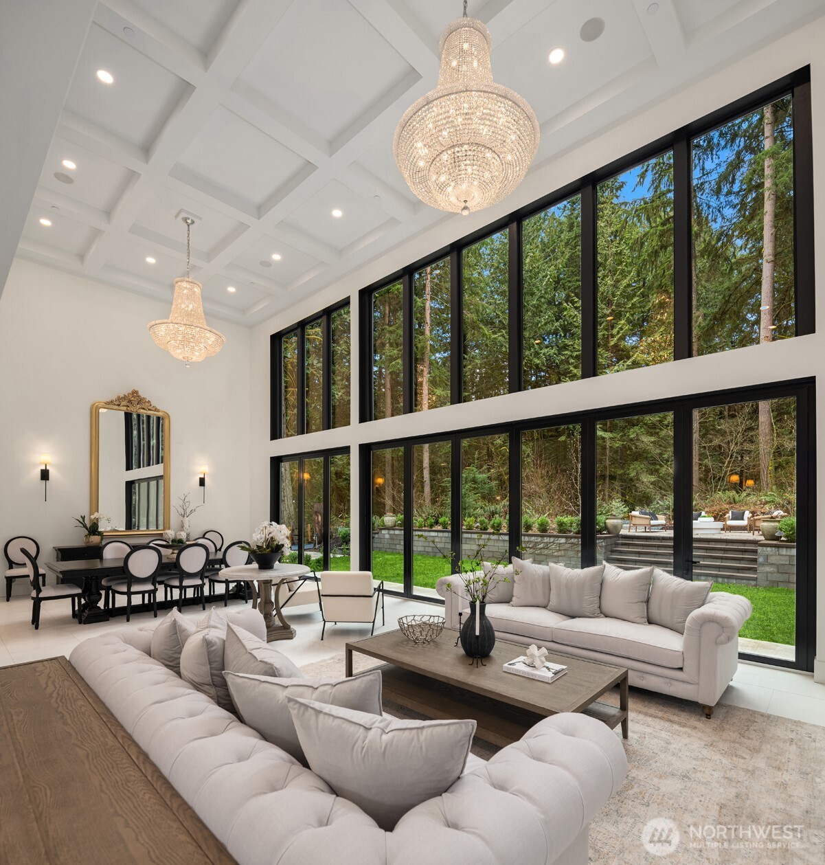 Great room with coffered ceilings and two elegant chandeliers