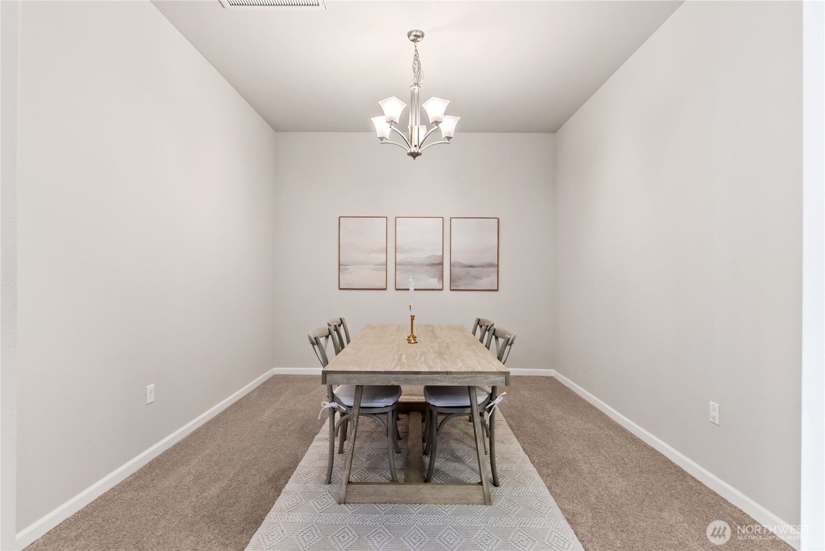 Elegant formal dining room with soaring ceilings, modern chandelier, and neutral tones that complement any décor. This spacious area is perfect for hosting gatherings, dinner parties, or enjoying everyday meals in a bright and refined setting.