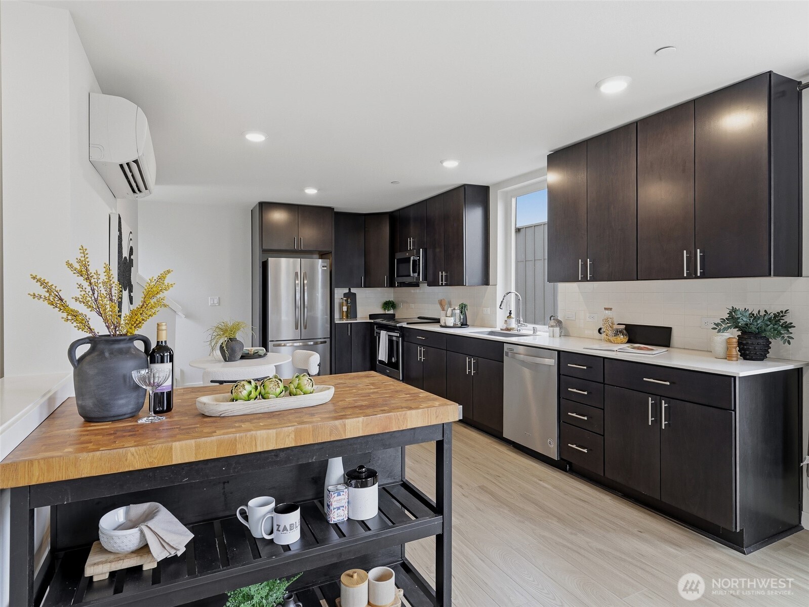 The kitchen has sleek stainless steel appliances and quartz countertops