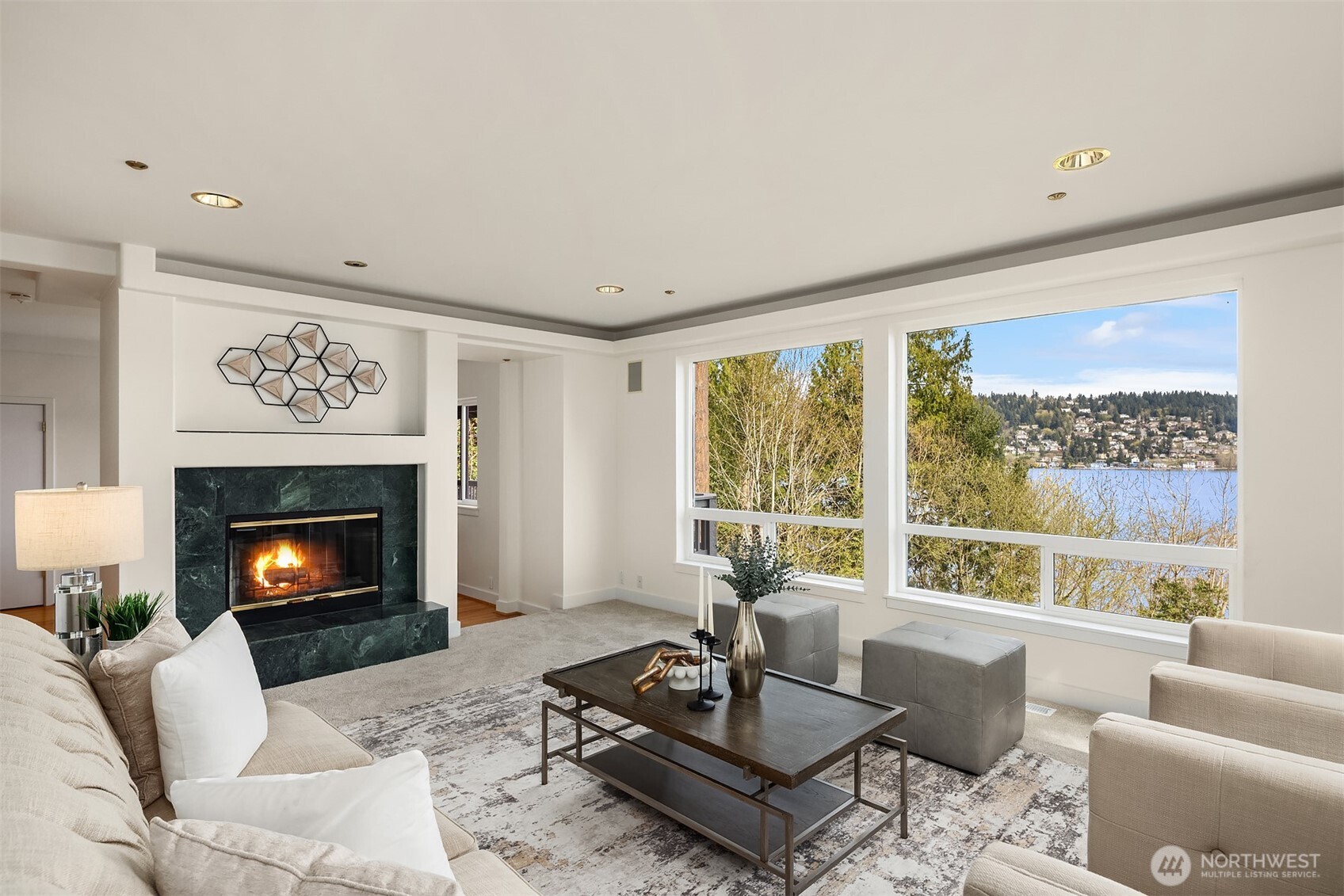 Large living area with picture windows, fill the home with light and it feels like you can almost touch the lake.