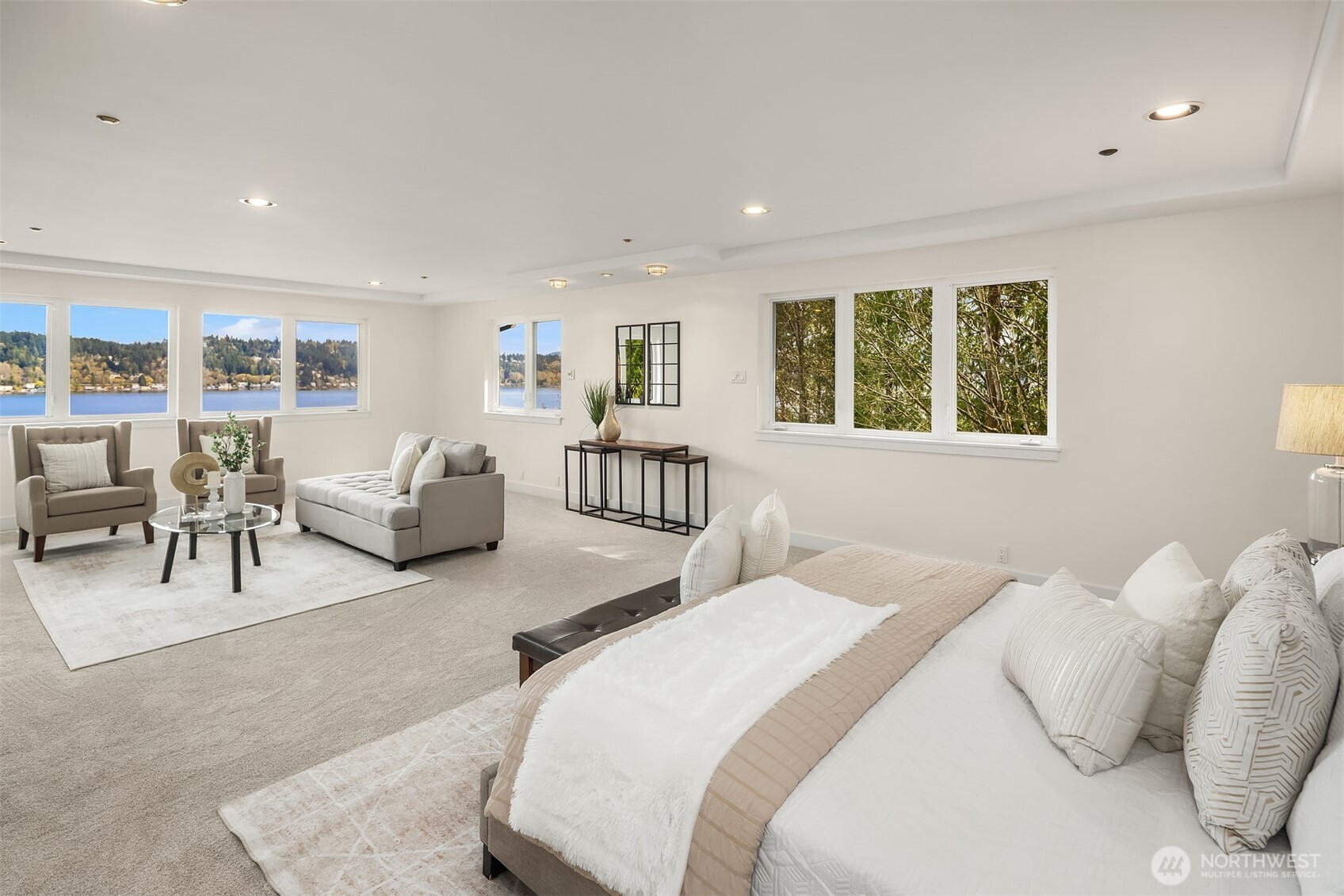 The primary suite is huge, with jaw droppingly gorgeous lake views. With a king sized bed, and a large sitting area, there's still oodles of room. Not shown is two enormous primary closets, and ensuite bathroom.