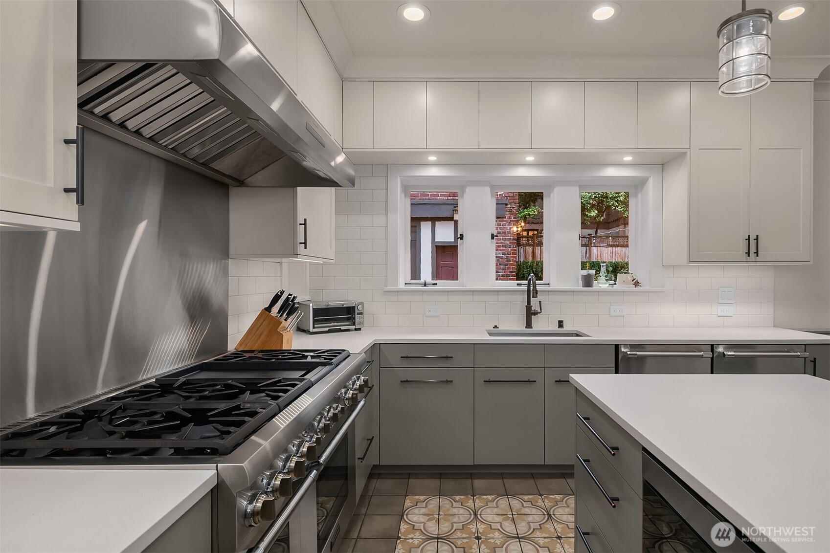 The custom cabinets extend to the ceiling. No wasted space here! A walk-in pantry and mudroom are conveniently located off the kitchen.