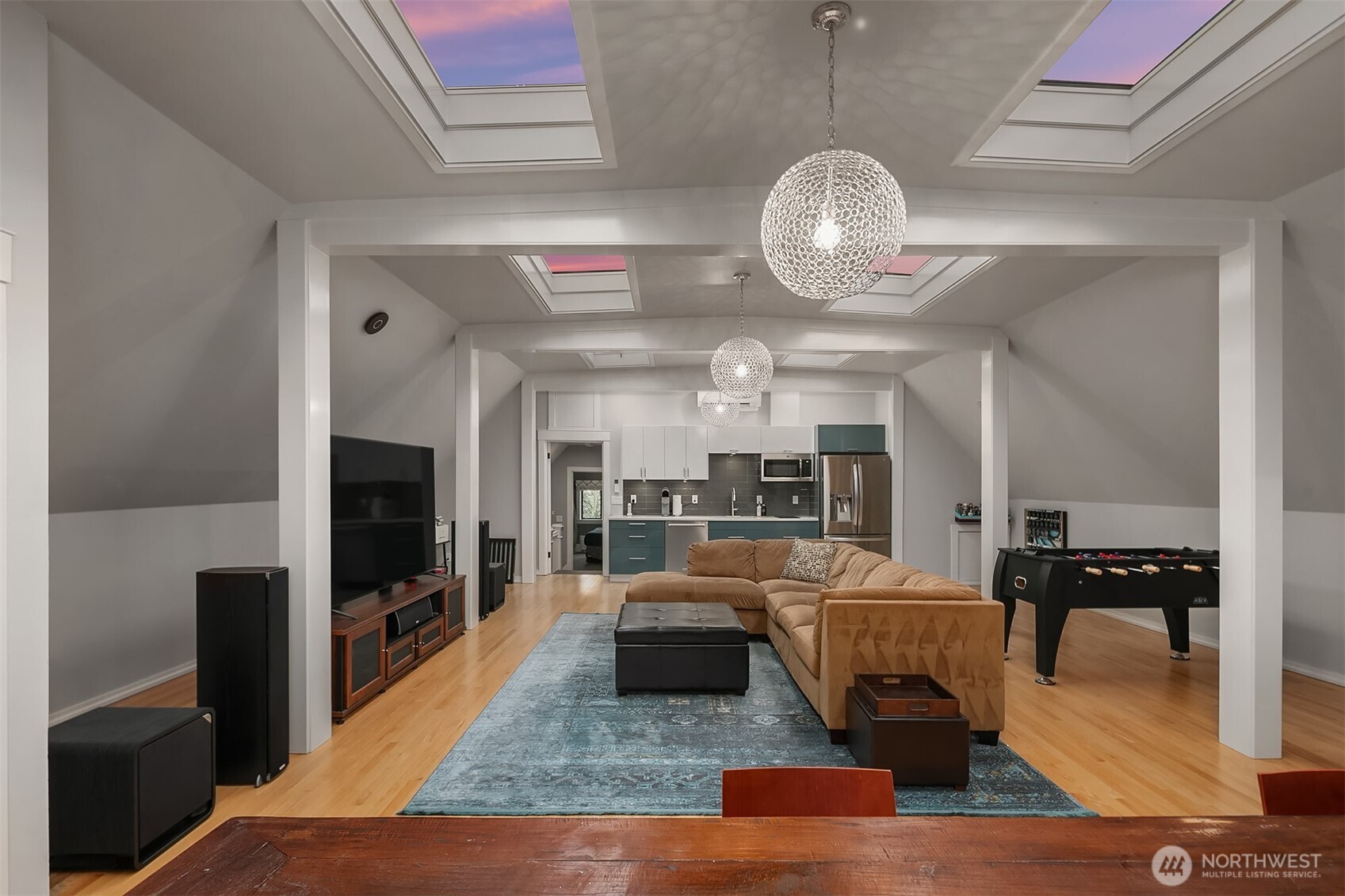 The family room is approximately 36 feet by 26 feet 8 inches. It is HUGE. The full kitchenette features a 2 burner stove, a built-in microwave, a dishwasher and a full-size refrigerator. Note the skylights.