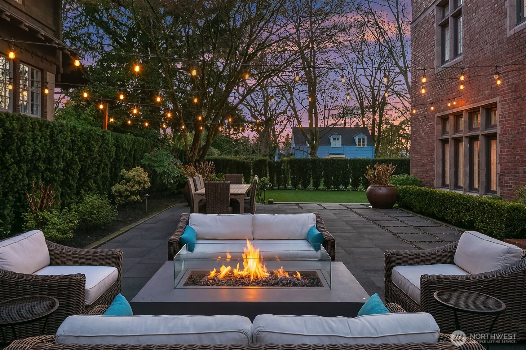 The outdoor kitchen includes a built-in barbecue connected to natural gas, a refrigerator, storage and a prep counter.
