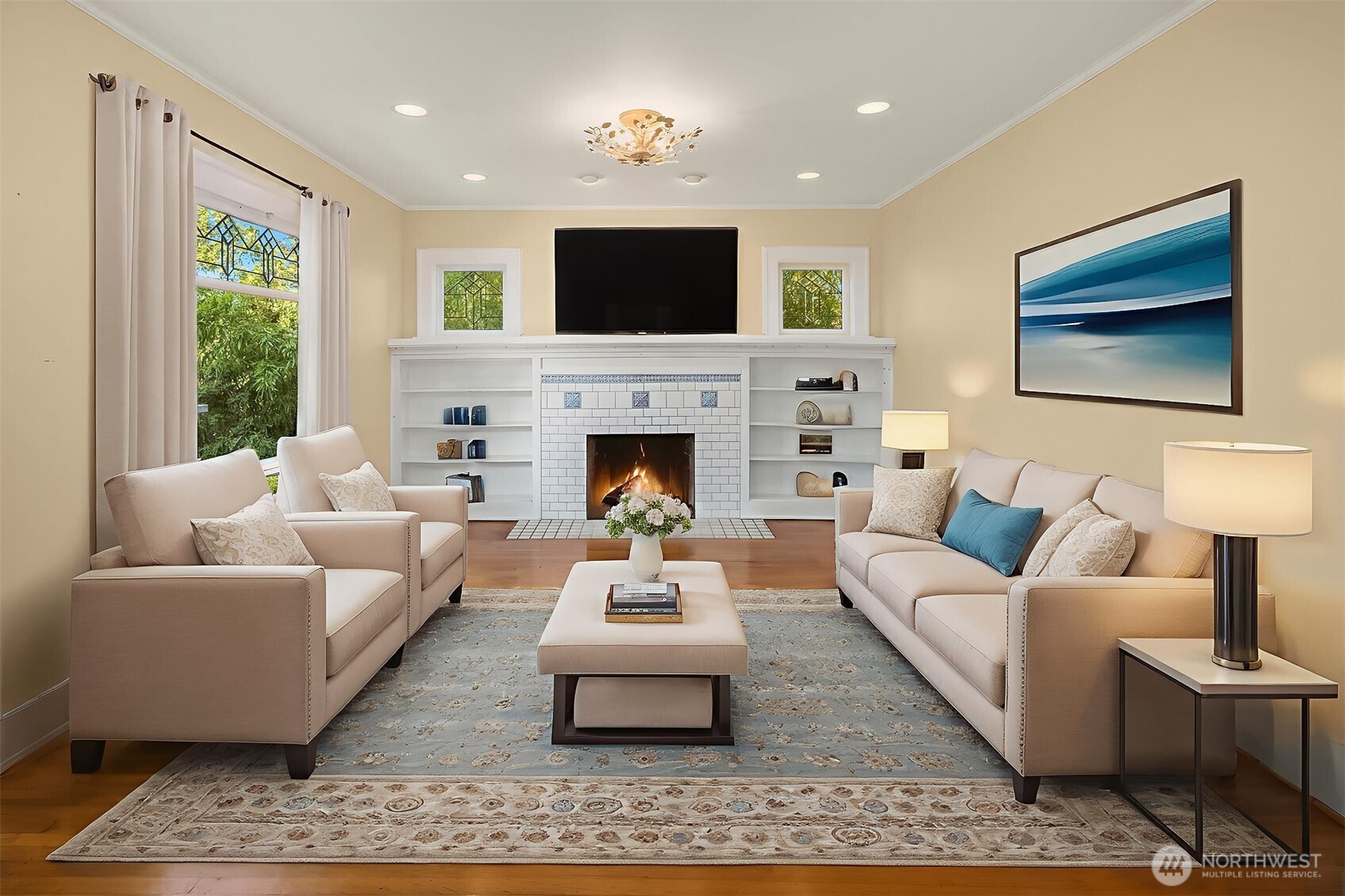 Enter into a large living room with leaded glass windows, built ins and woodburning fireplace