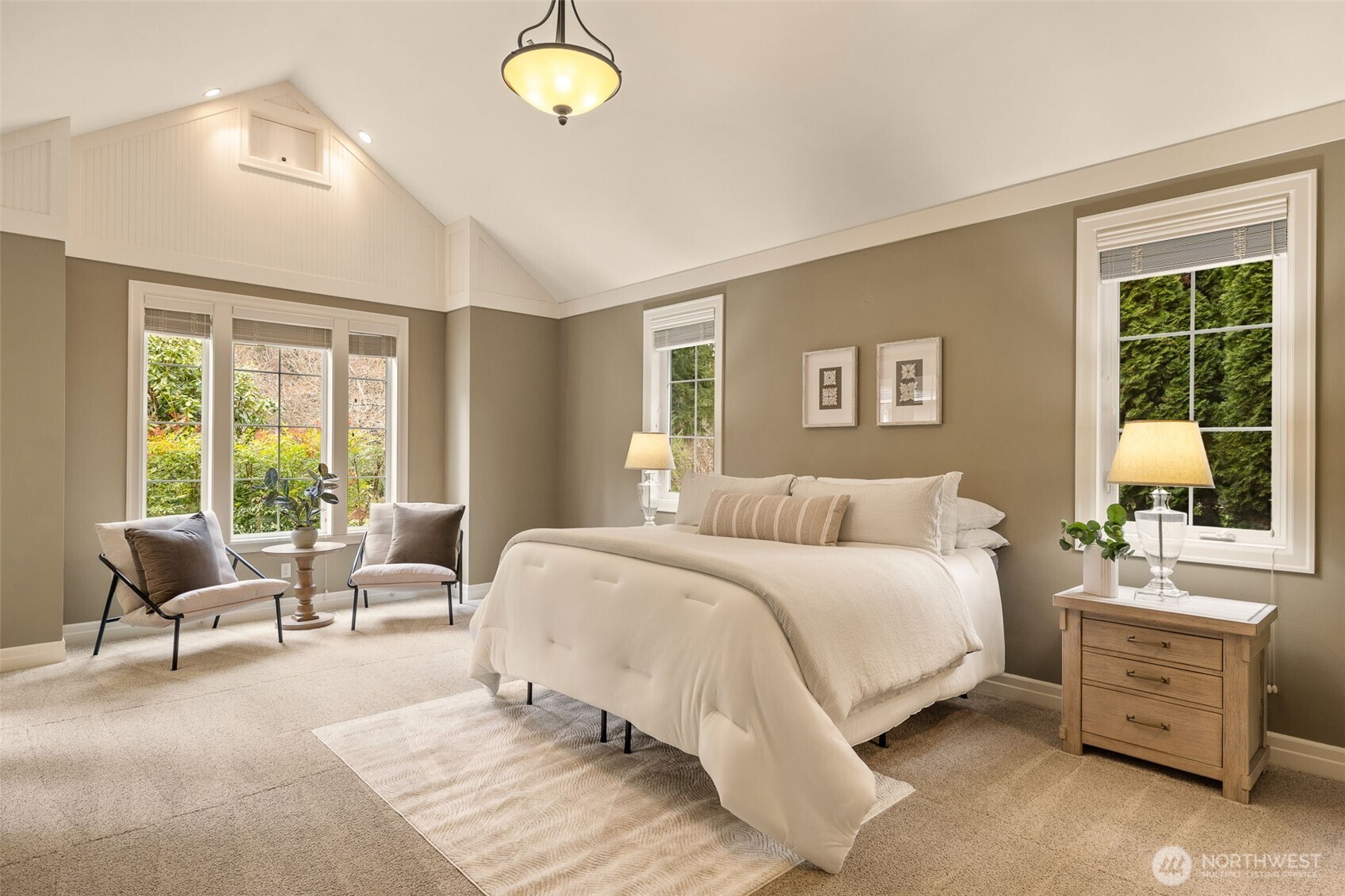 End the day in this welcoming main floor primary with vaulted ceilings and lots of windows.