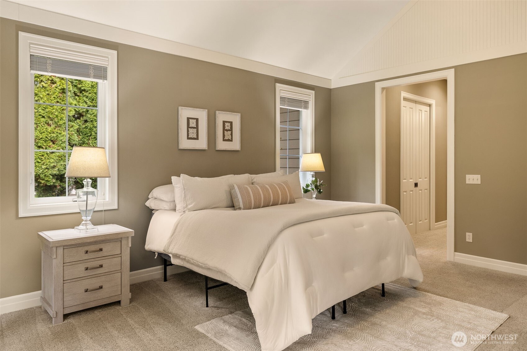 The hallway to the primary bath has a walk-in closet (shown with doors closed) and another closet across from the walk-in.