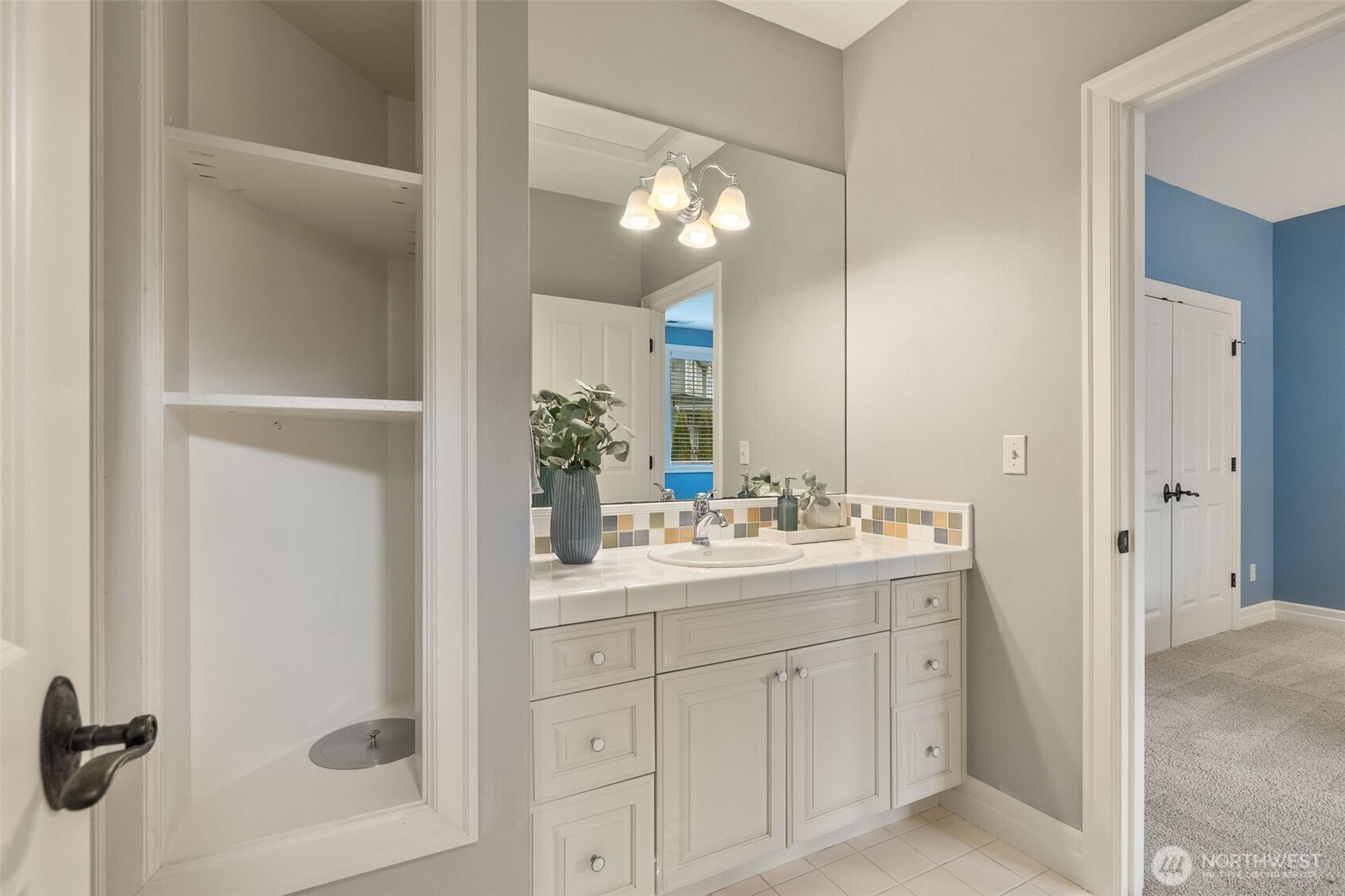 Sink attached to blue bedroom. There's the laundry chute!