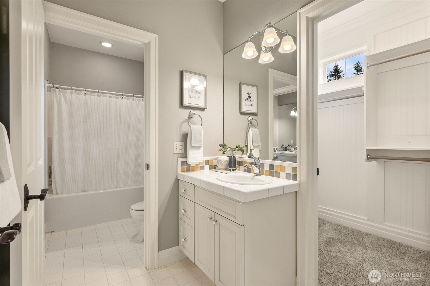 Sink and closet attached to the tan bedroom. Shower/tub and toilet shared by the blue and tan bedrooms.