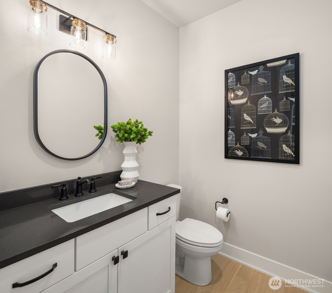 Stylish powder room with contemporary vanity and fixtures.