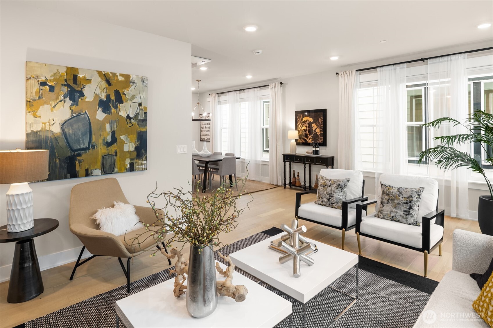 Bright and welcoming main level with wide-plank white oak flooring and large windows throughout.