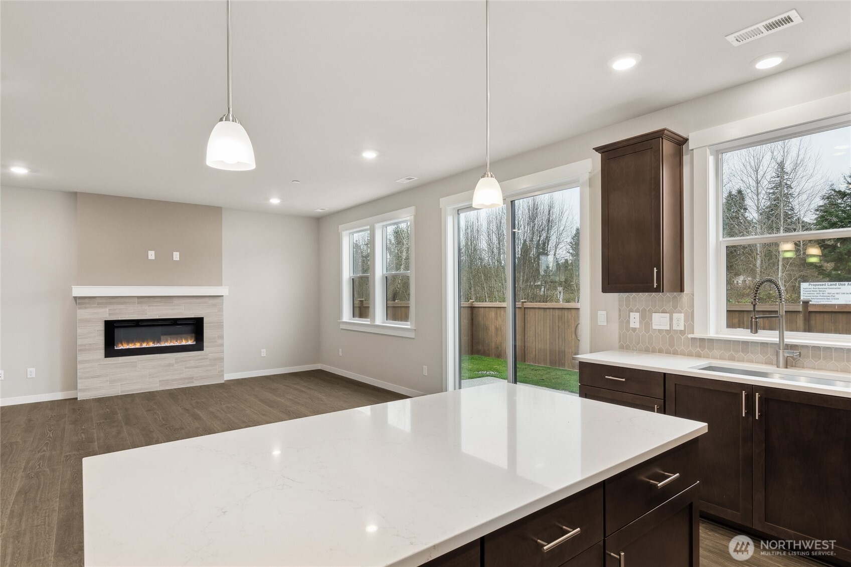 Kitchen opens to great room - home for sale is on a corner homesite and is very private and will include white cabinetry.