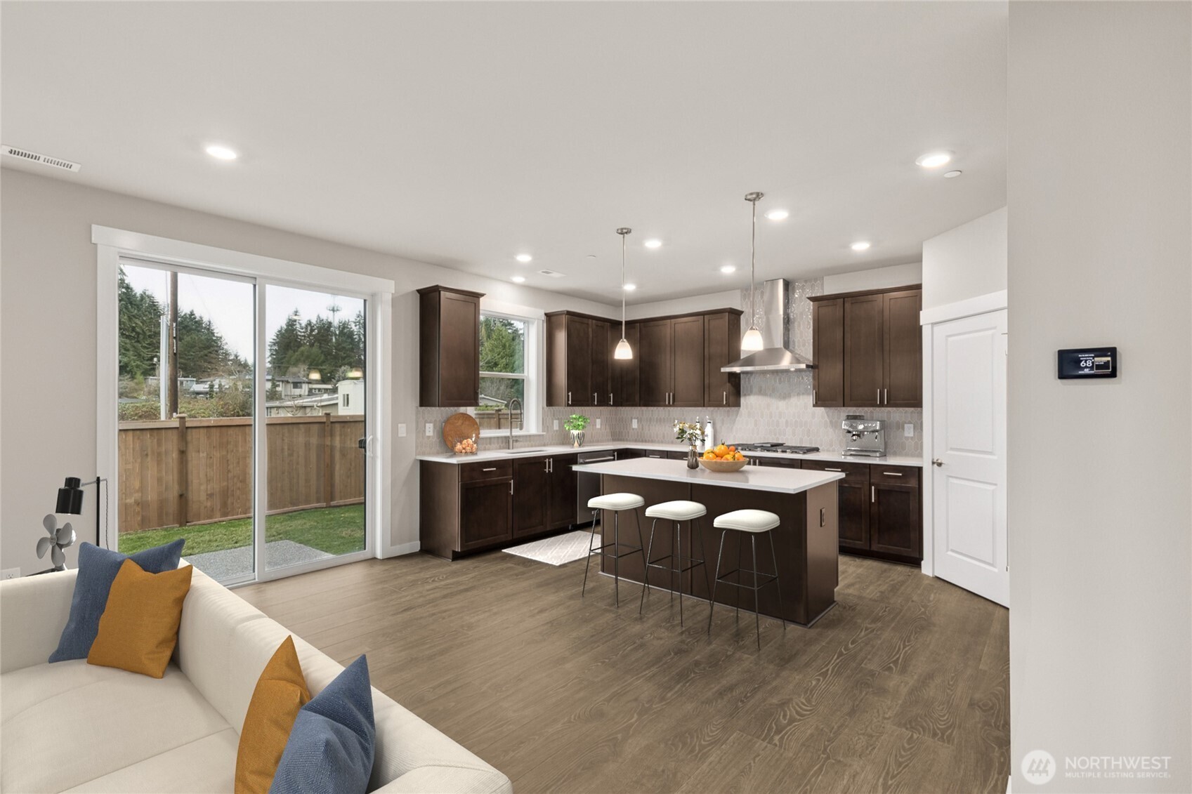 Well-appointed kitchen with gas cooktop, 48" counter depth side-by-side refrigerator. Plenty of space to entertain!  Very open layout, view will vary as this was from the same plan within the community -