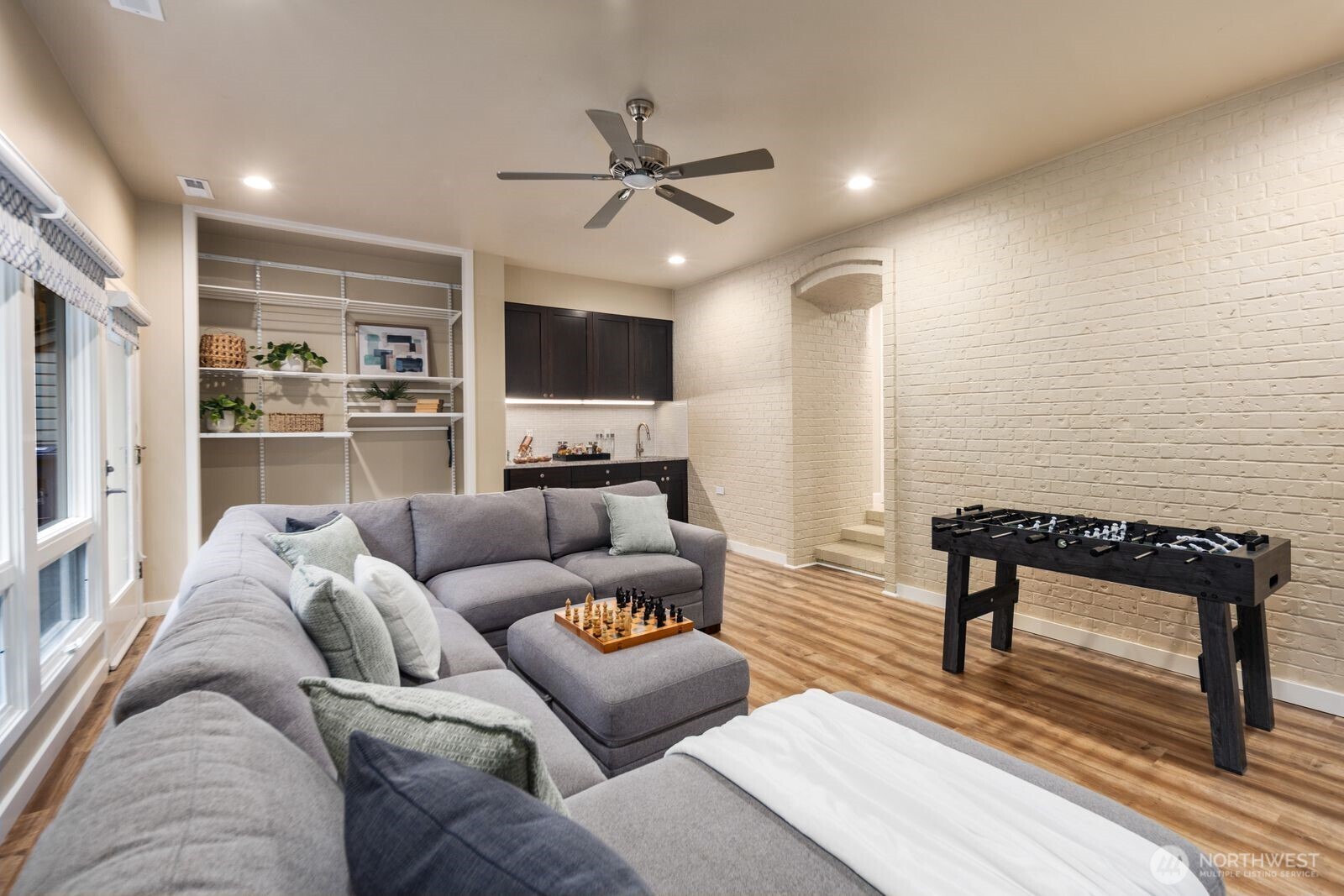 A spacious secondary living area with a well-appointed kitchenette