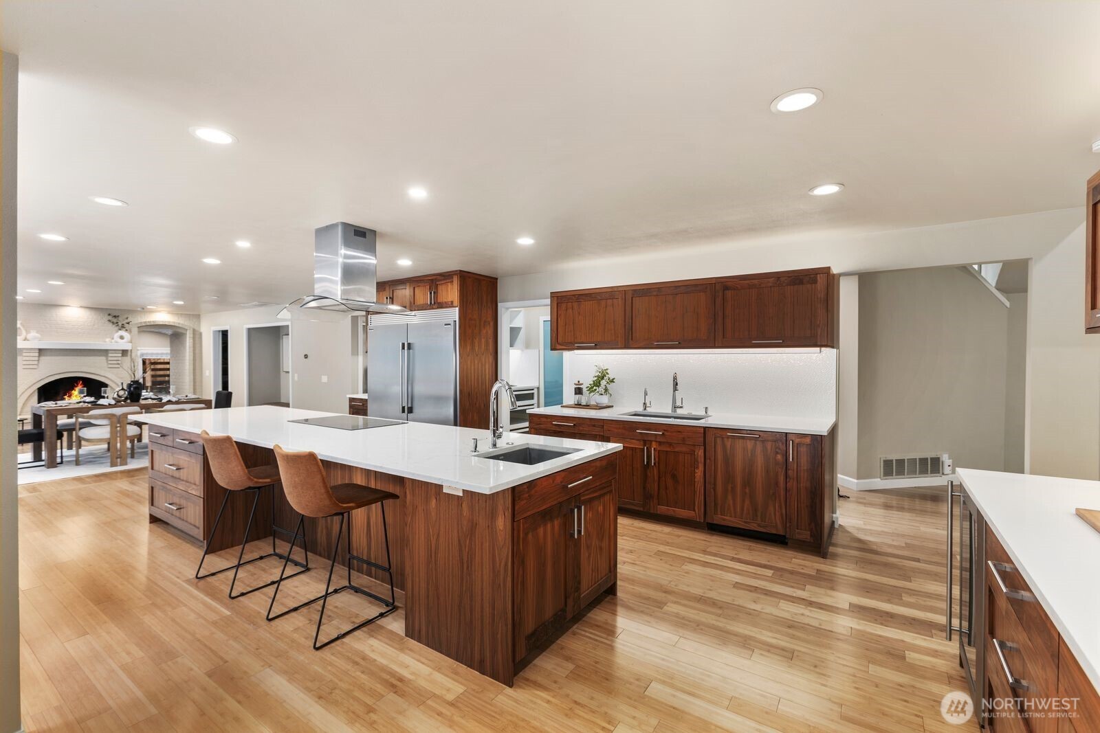 The CHEF’S KITCHEN features abundant cabinetry, a 10+ ft quartz island