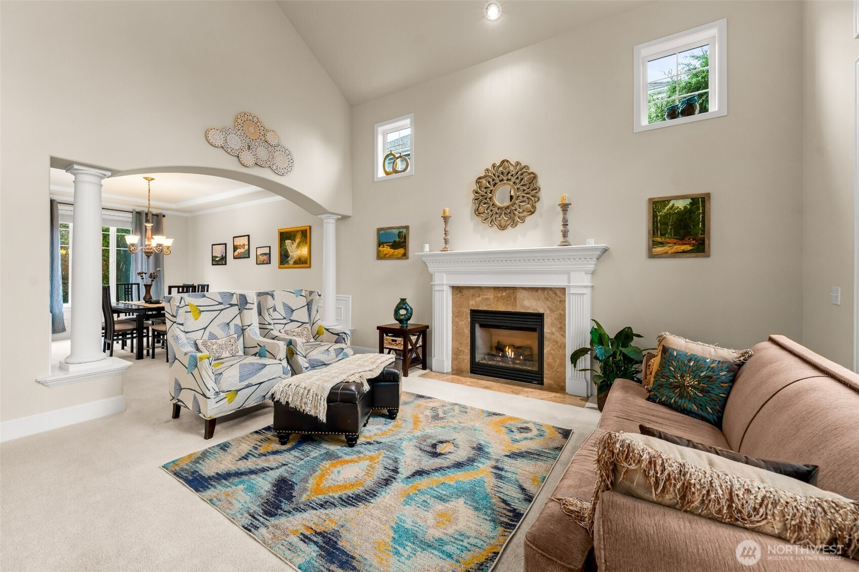 Formal living room with a gas burning fireplace connects to the well-appointed dining room