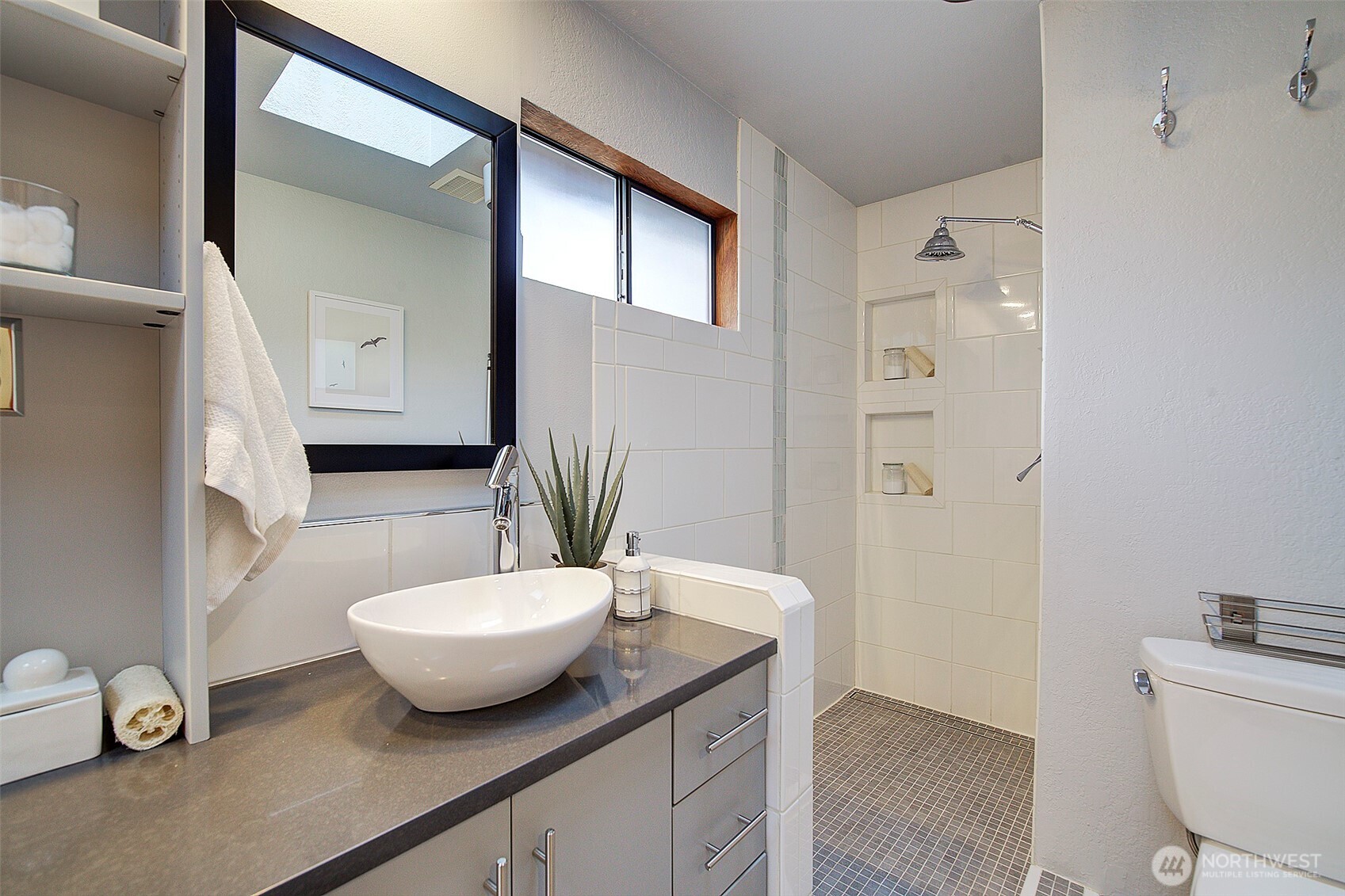 The primary bath includes modern finishes and features a walk-in shower.