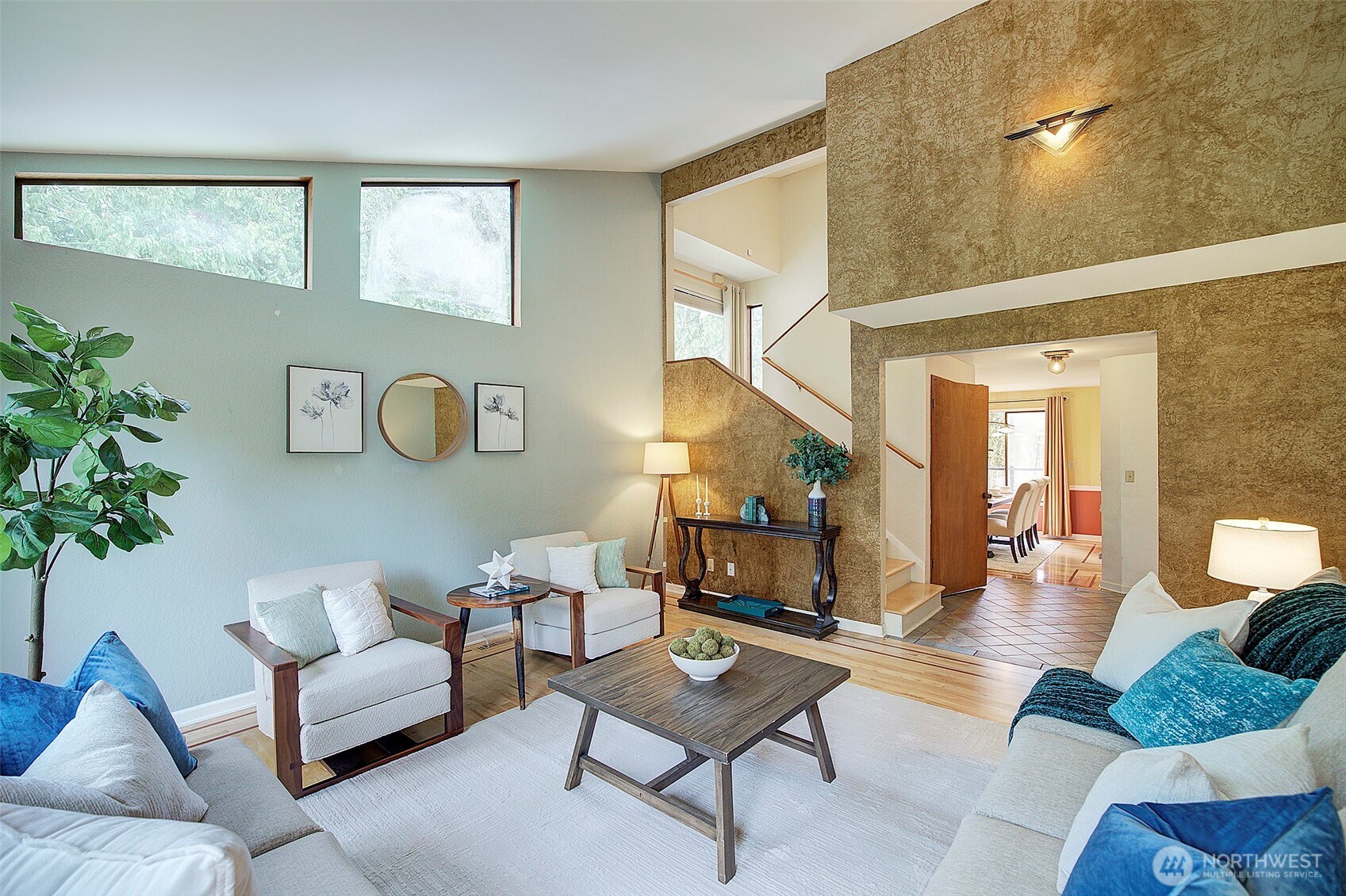 The dining room is finished with hardwood floors and features a vaulted ceiling.