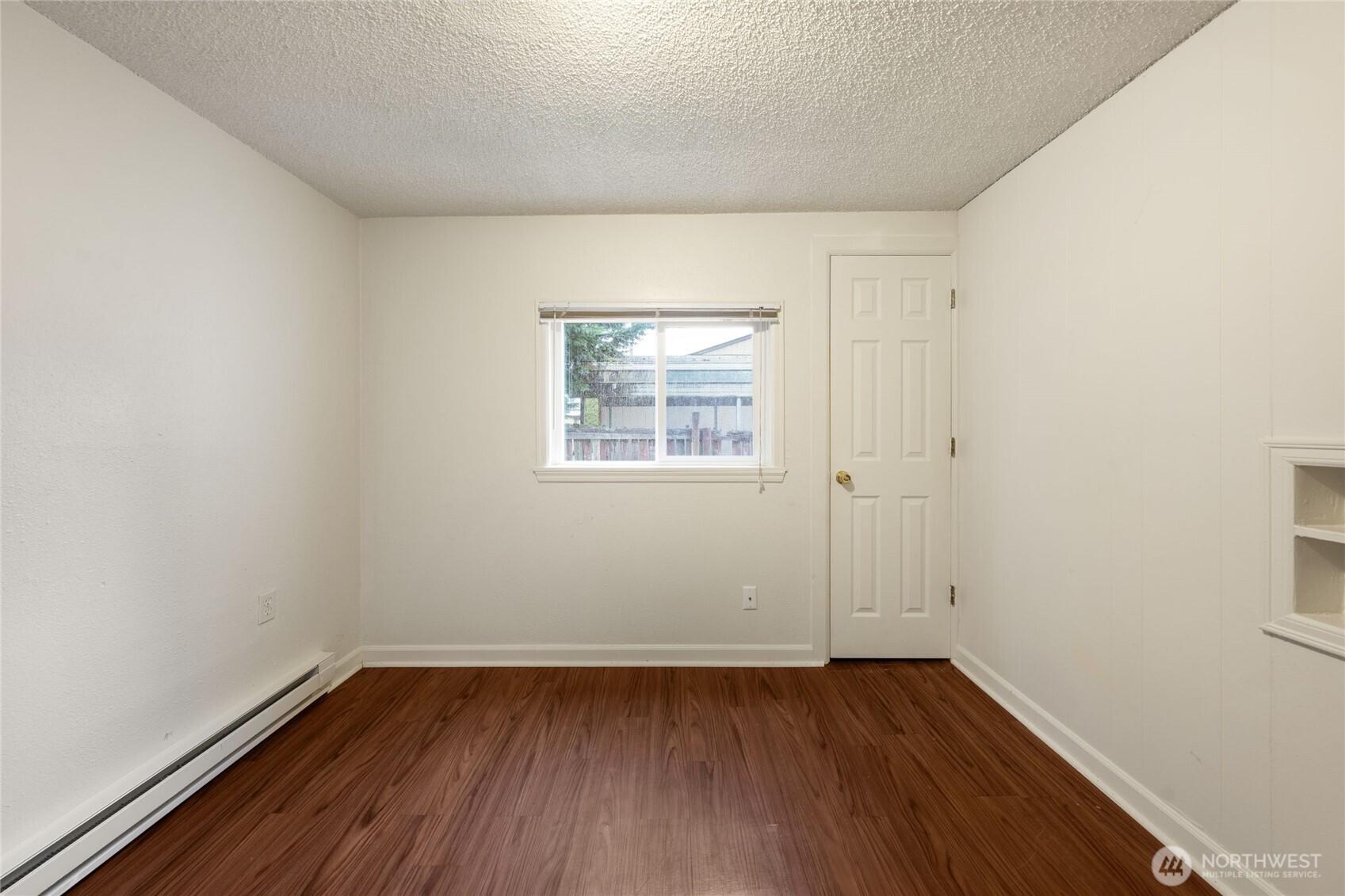 Functional utility room with dedicated laundry hookups and additional storage potential.