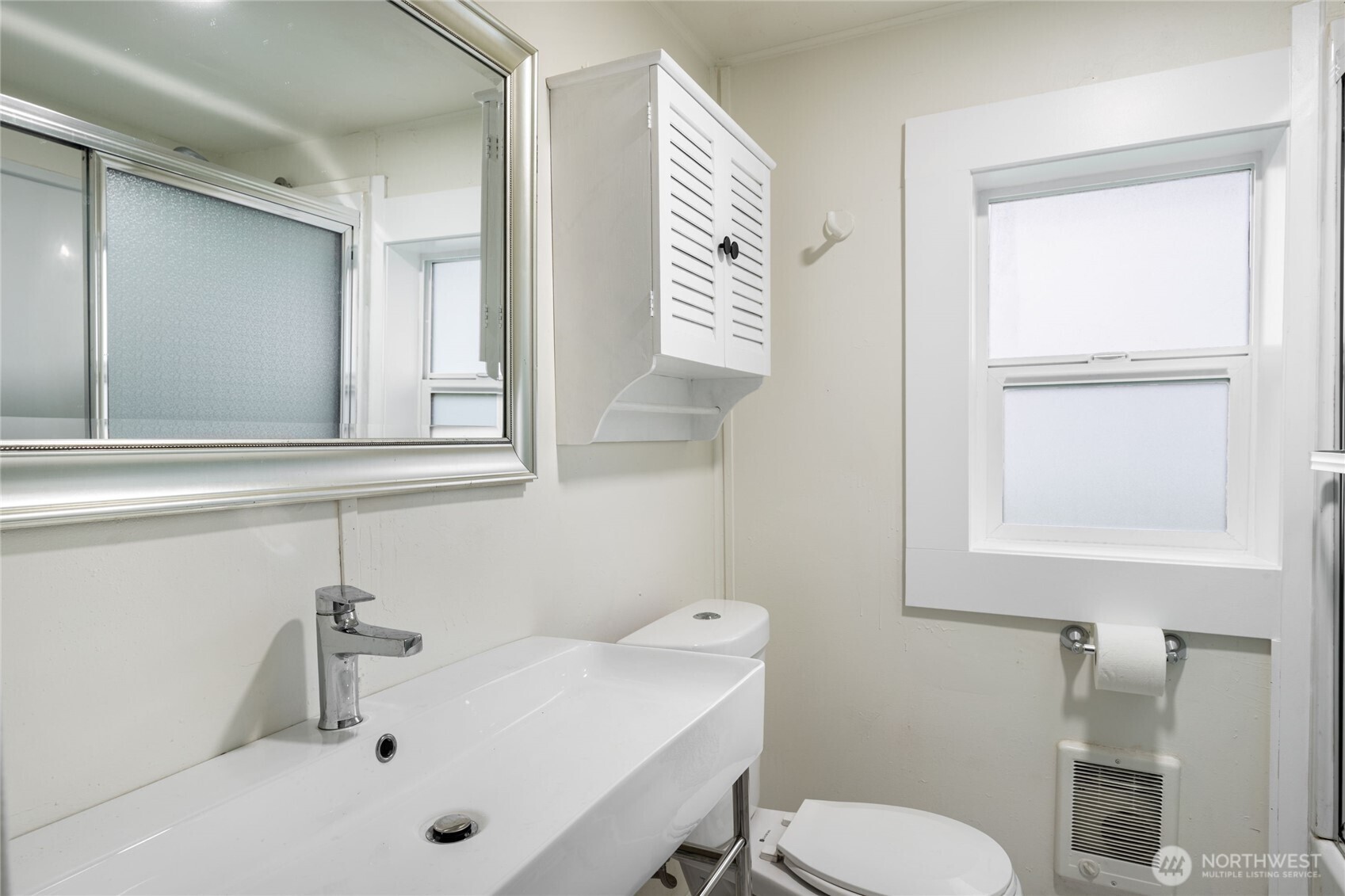 Stylish half bathroom, modern vanity and functional layout.