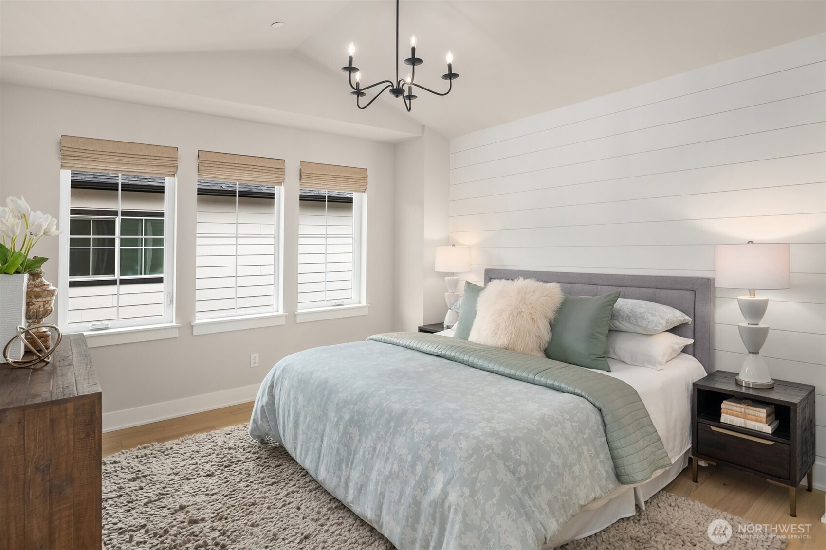 Primary bedroom retreat offering peaceful natural light and a comfortable, private setting with motorized blinds.