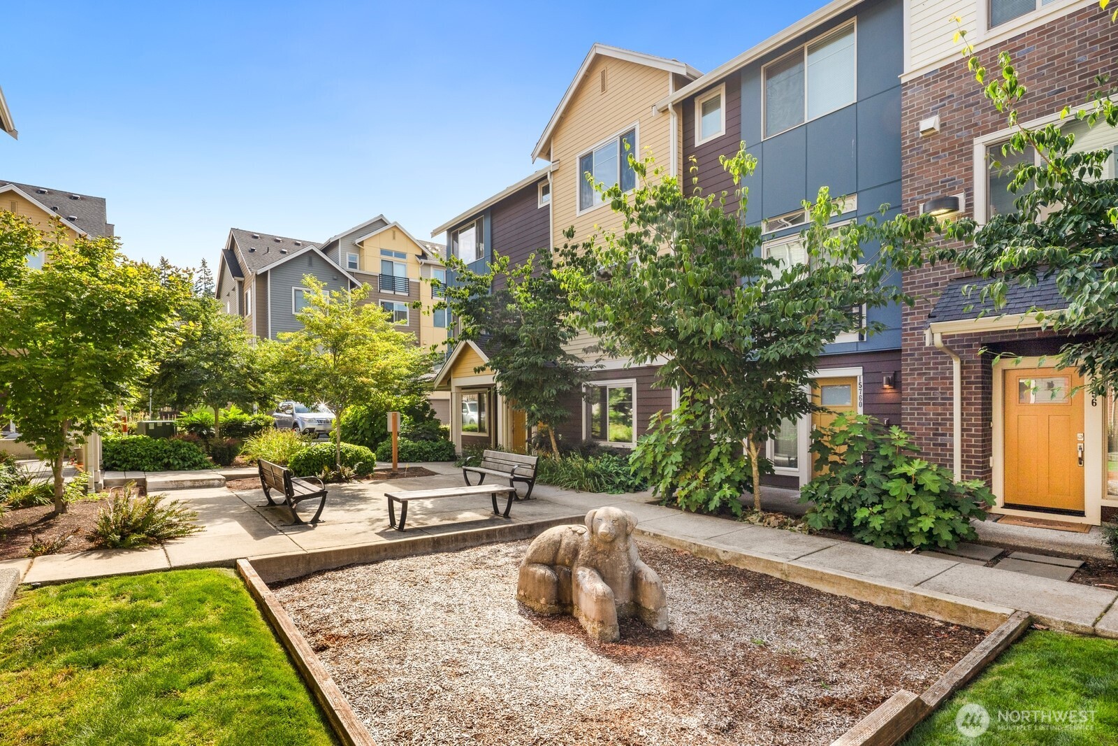 Courtyard features green space and play zones.