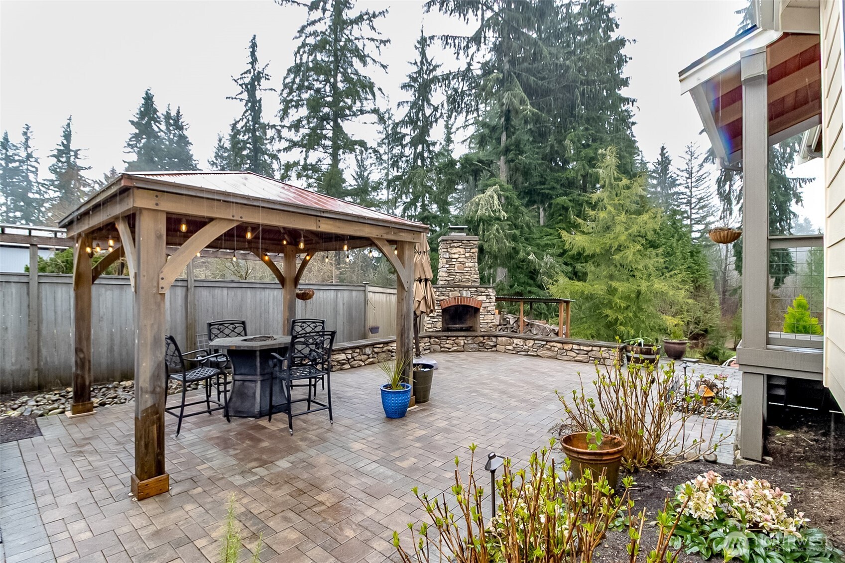 Back stone patio, gazebo and woodburning fireplace