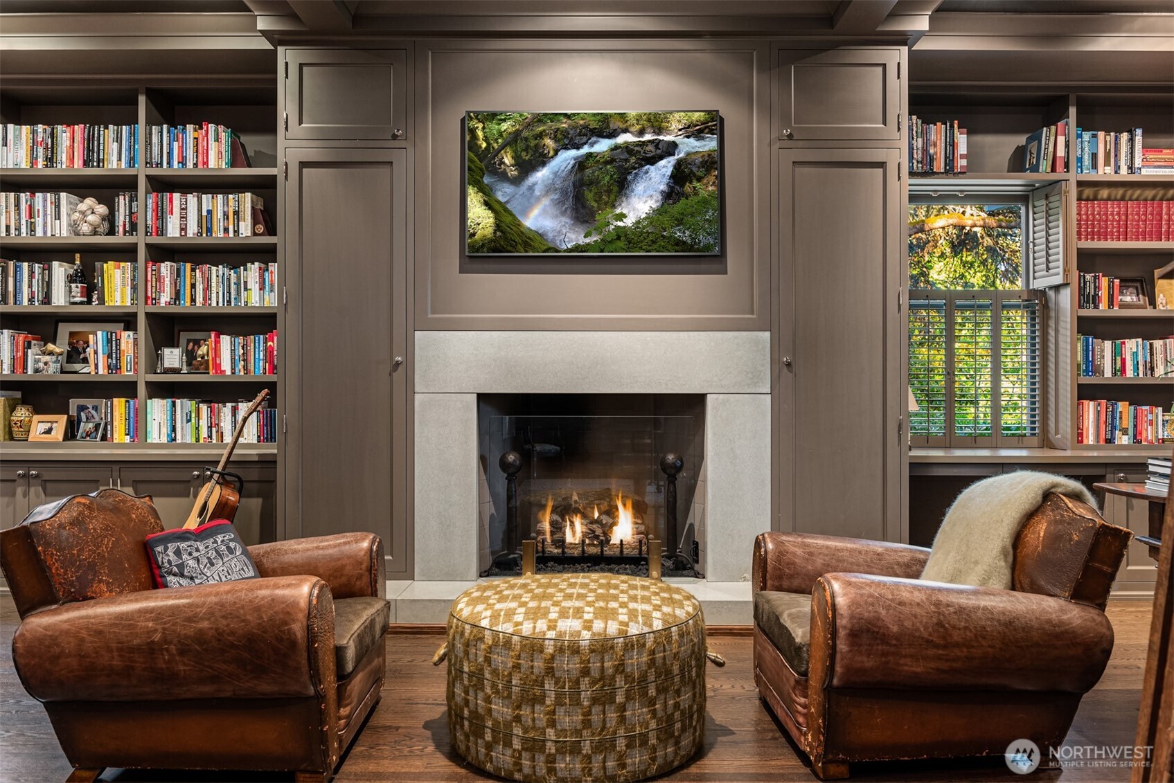 Take a meeting or cozy up to the fire with a nearby book in the library featuring a wet bar, refrigerator, wood burning fire with gas starter, storage for all.