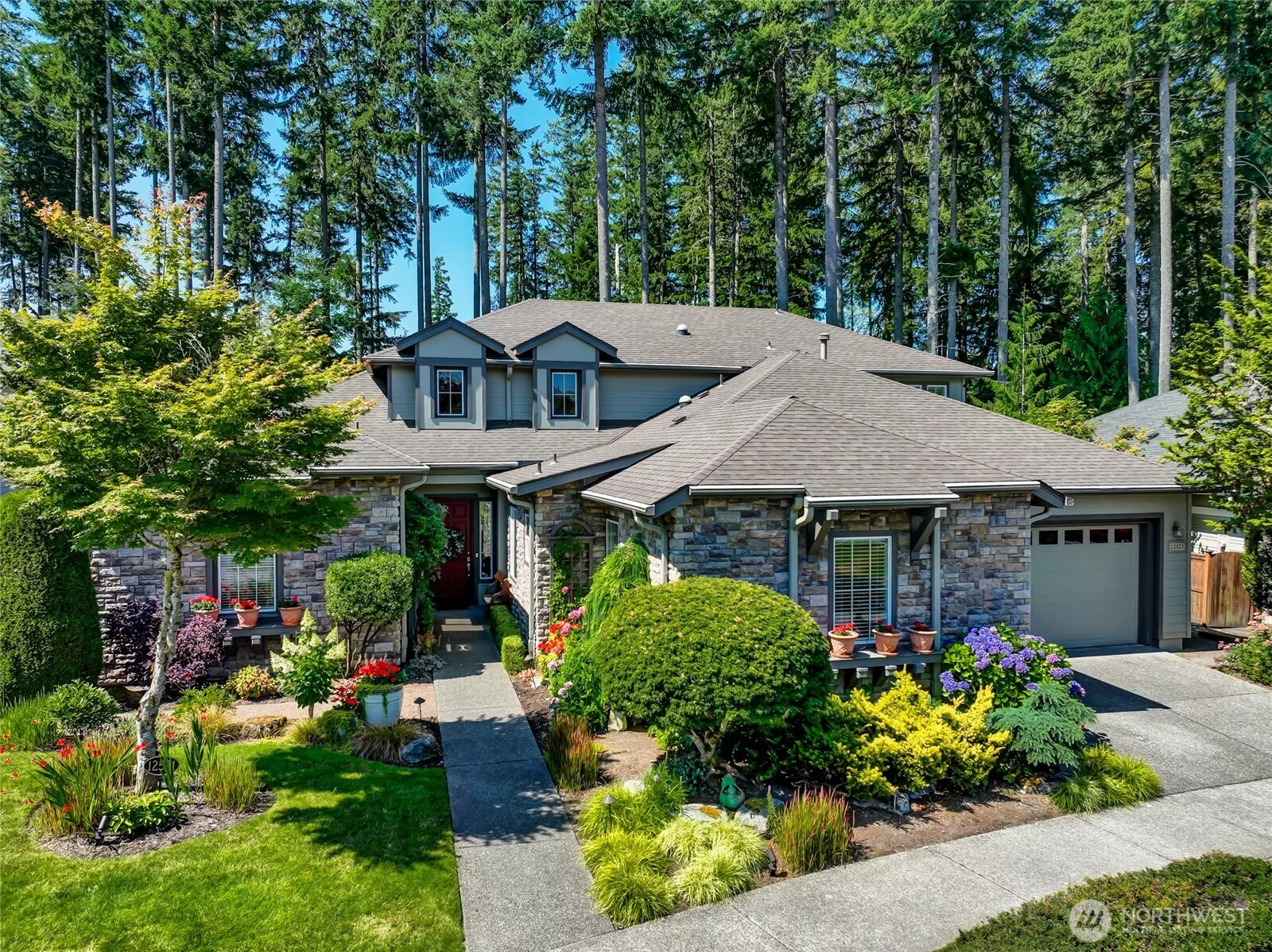 A truly unique Maryhill plan home and yard with privacy galore in the backyard where you are surrounded by gorgeous gardens.