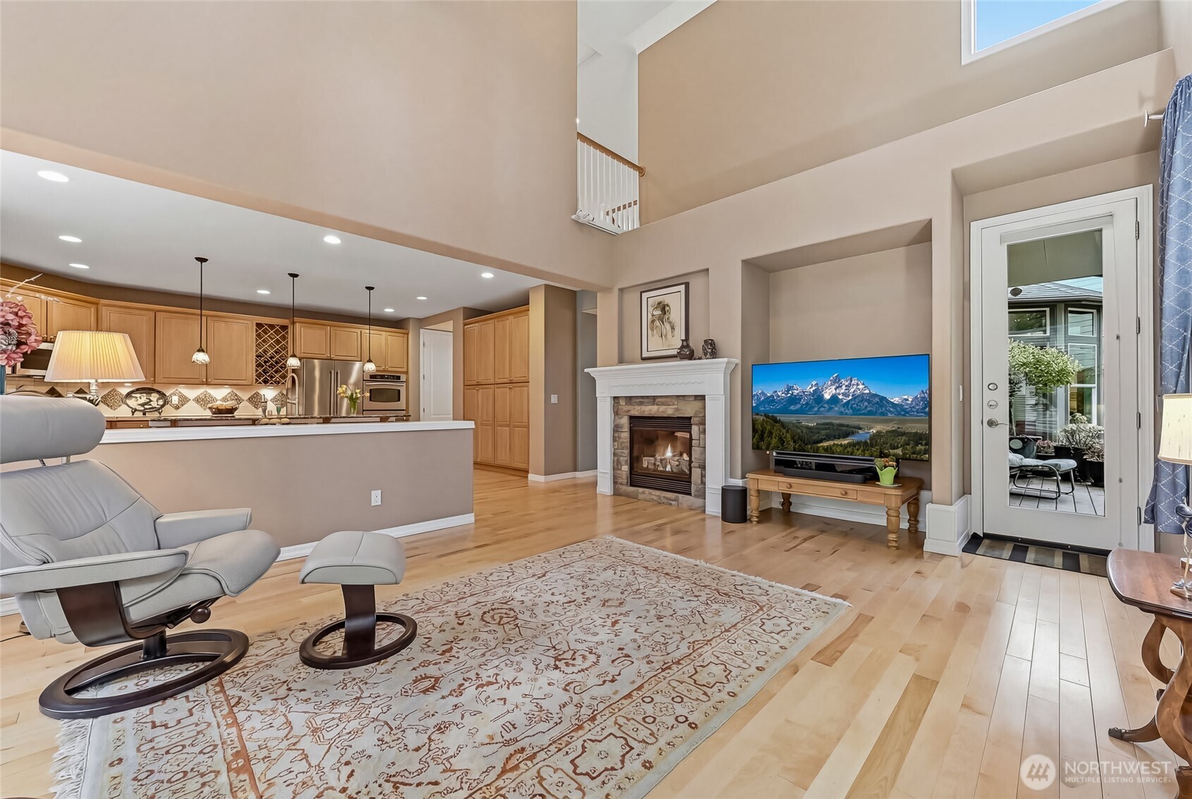 The primary suite is very serene with a lovely curved wall of windows and a glass door to the deck.