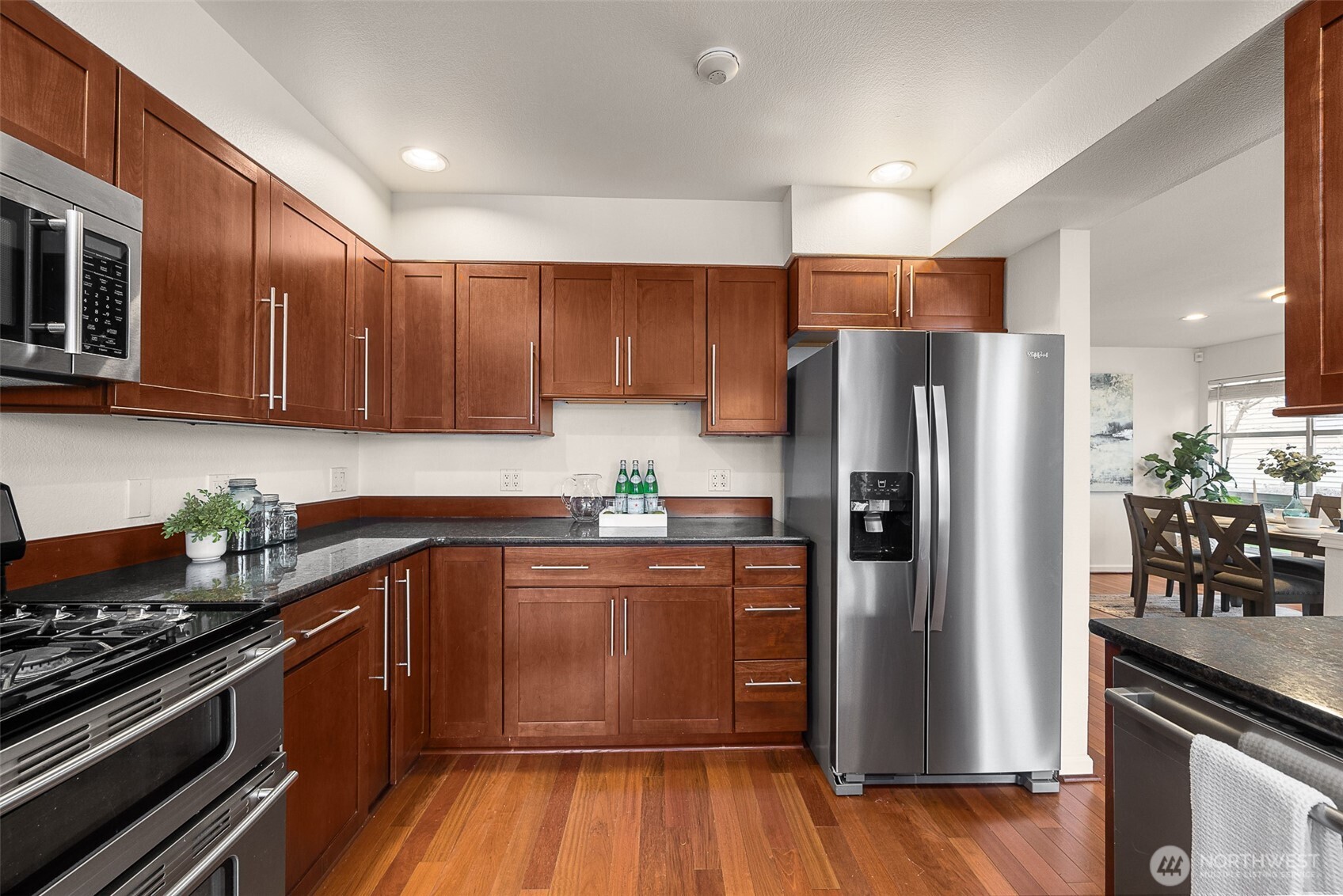 The L-shape island anchors the Kitchen footprint with extra counter space and storage cabinetry