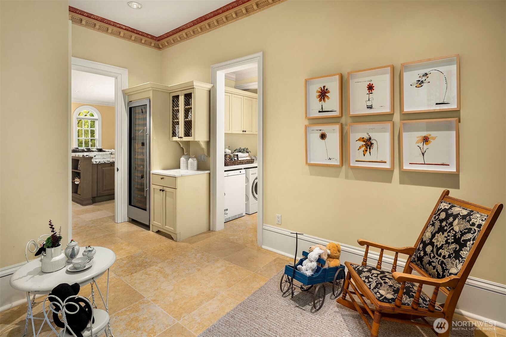 Kitchen adjacent flex room with SubZero 120+ bottle wine fridge and 950+ bottle wine cedar storage area. This room is conveniently located next to the main-floor laundry room and a mudroom with exterior doors to the side yard and garage.