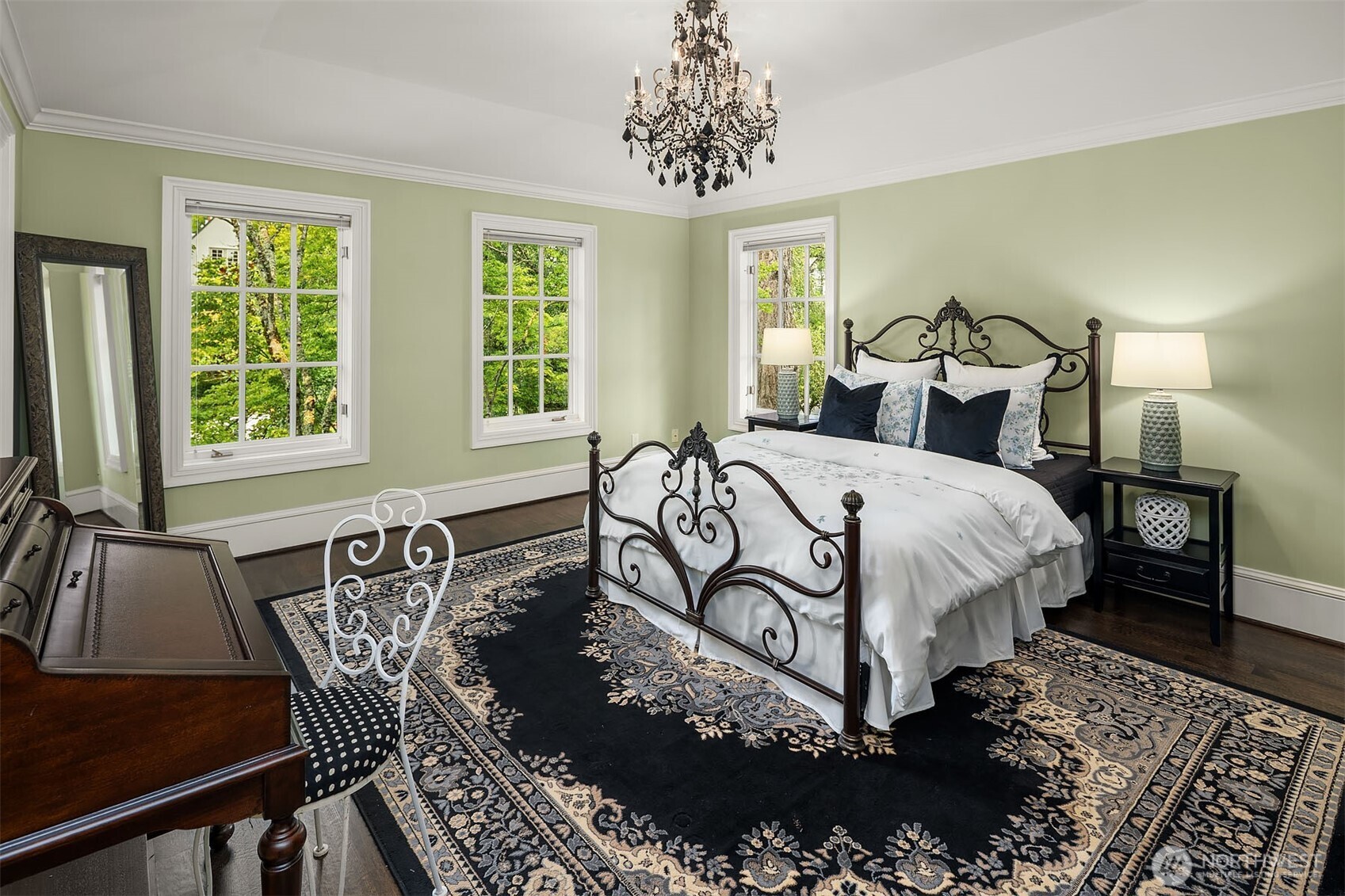 Fourth bedroom with crystal chandelier, en-suite full bathroom, and balcony.
