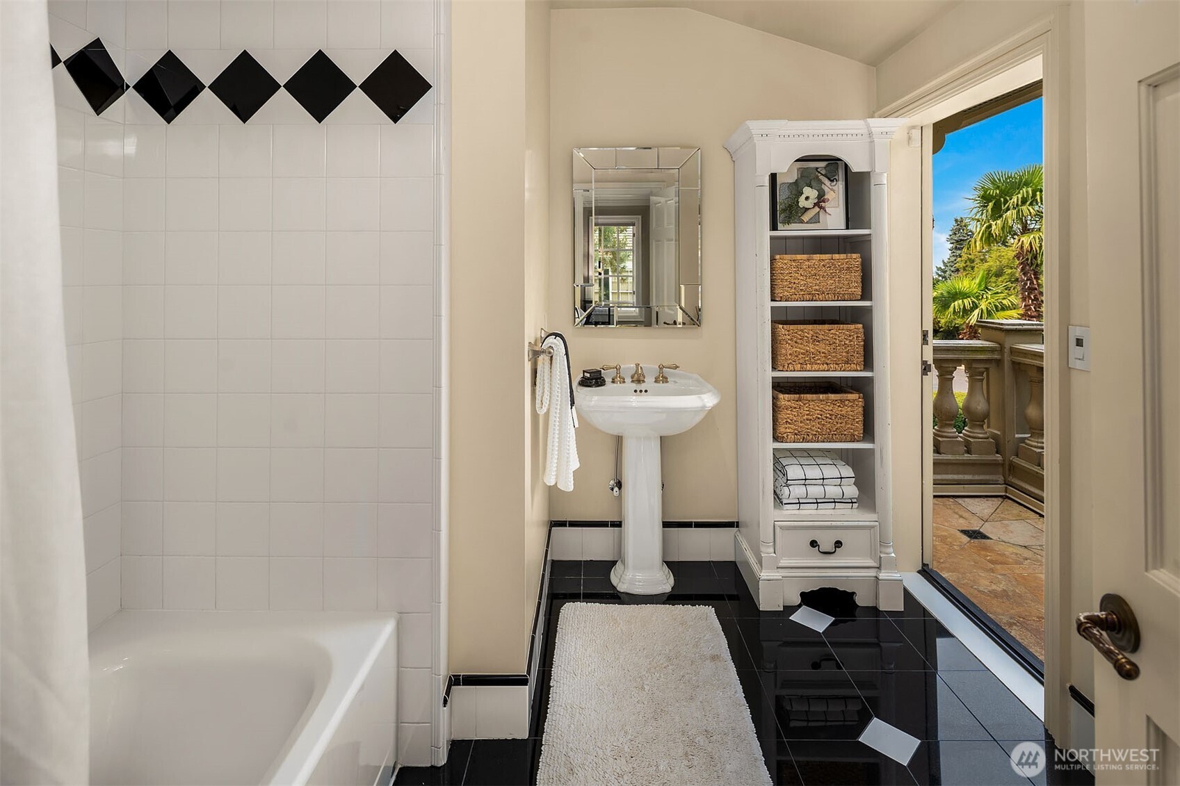 En-suite bathroom to fourth bedroom with balcony.