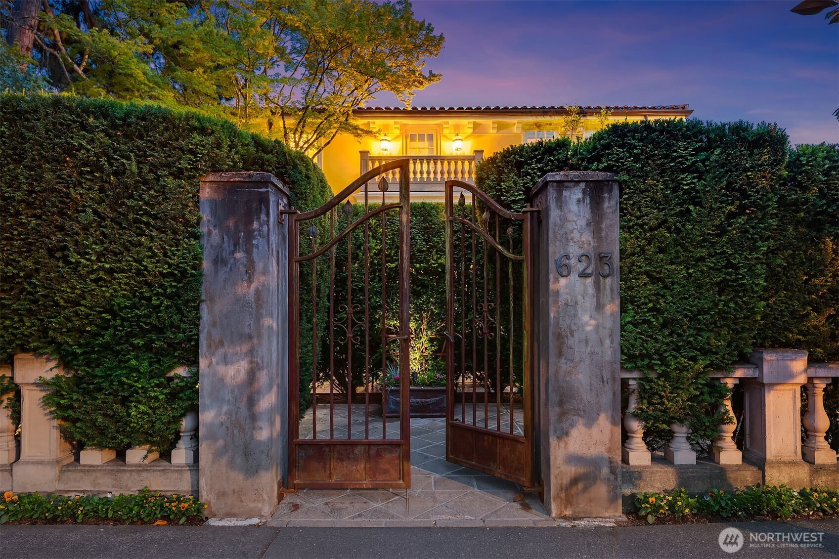 The ornate, wrought-iron gated entry creates a dramatic entrance on West Highland Drive.