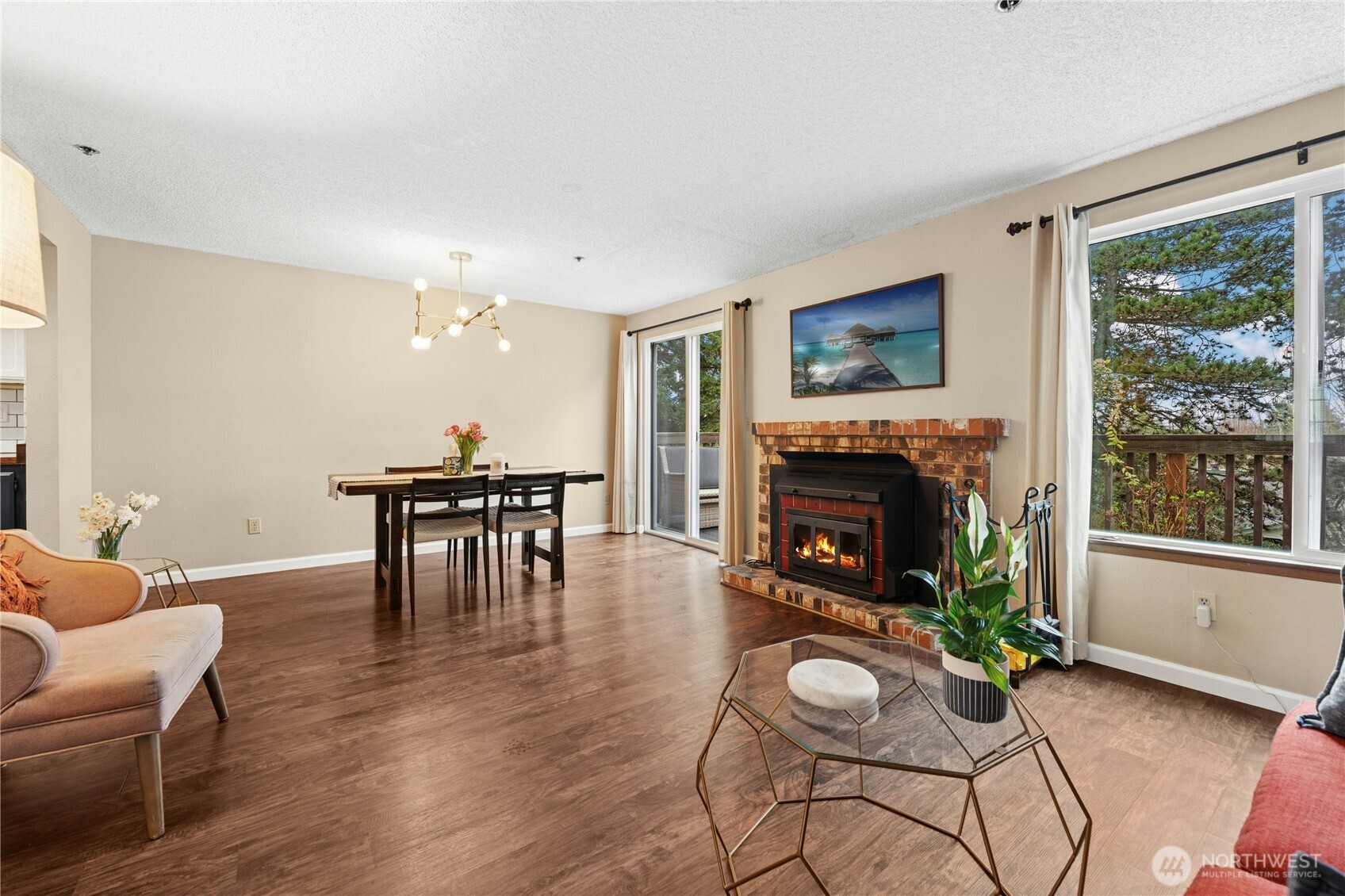 Living and dining with access to full length deck. Newer laminate flooring.  Wood stove.  Last special assessment-New roof, siding, windows, sliding glass doors, exterior painting, trex-type decking.