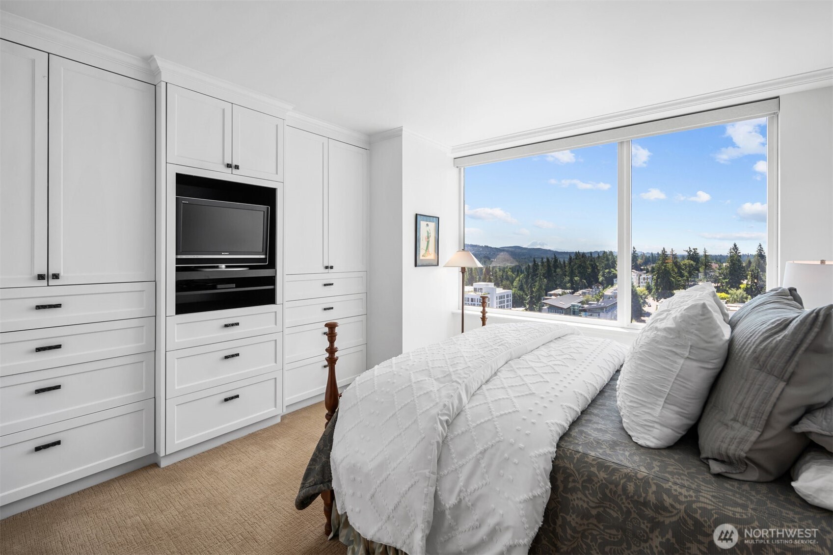 19th floor residence with sweeping city skyline, water, and mountain views from expansive windows.