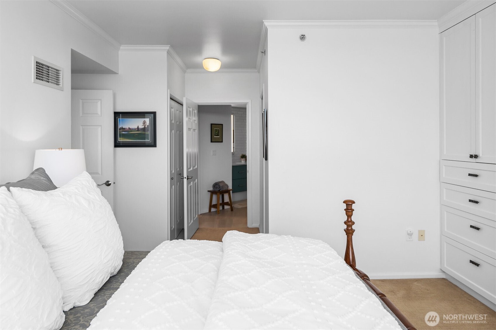 Primary bedroom with large windows capturing city and mountain views.