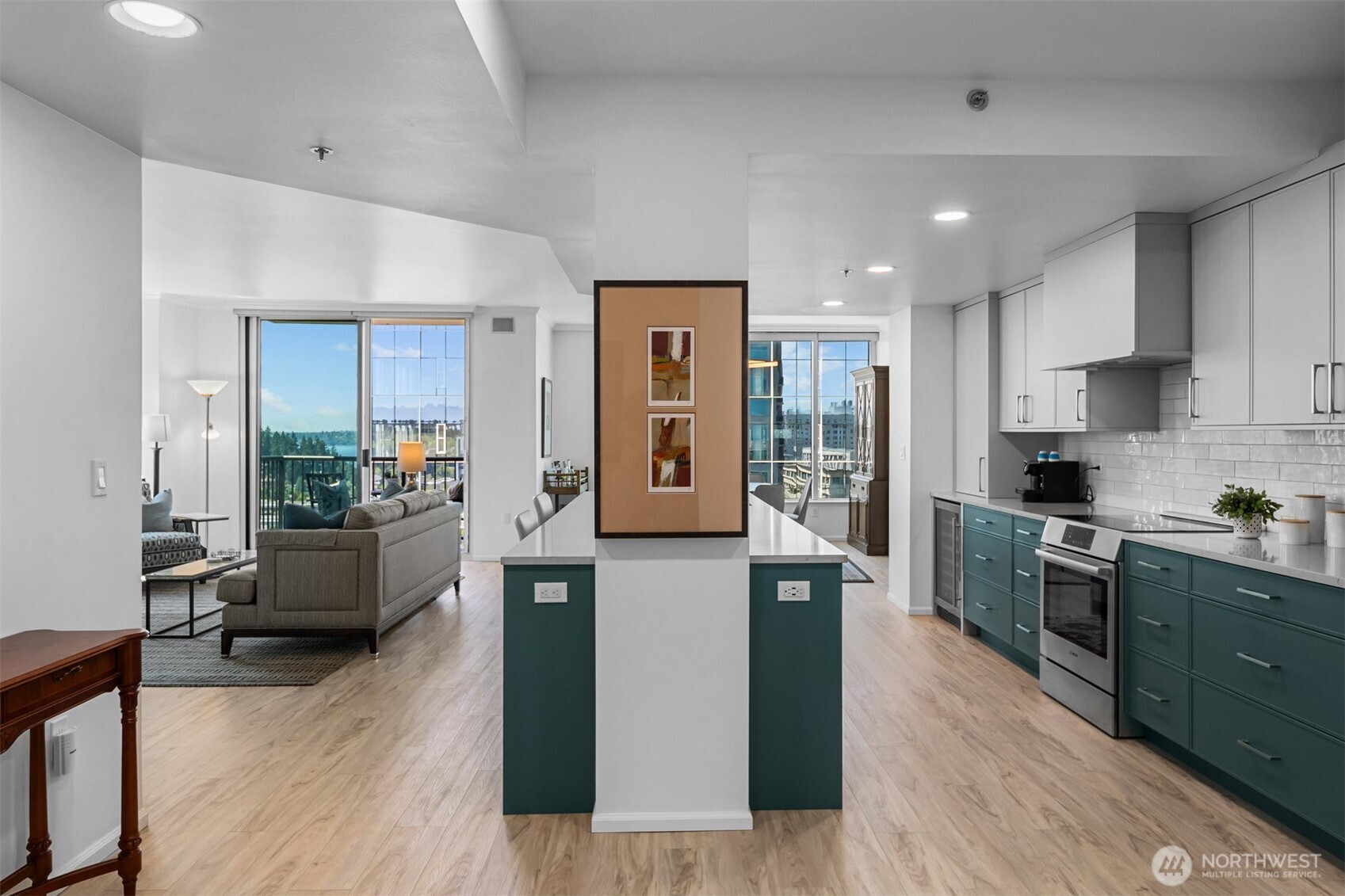 Open concept living room with expansive windows capturing natural light and skyline views.
