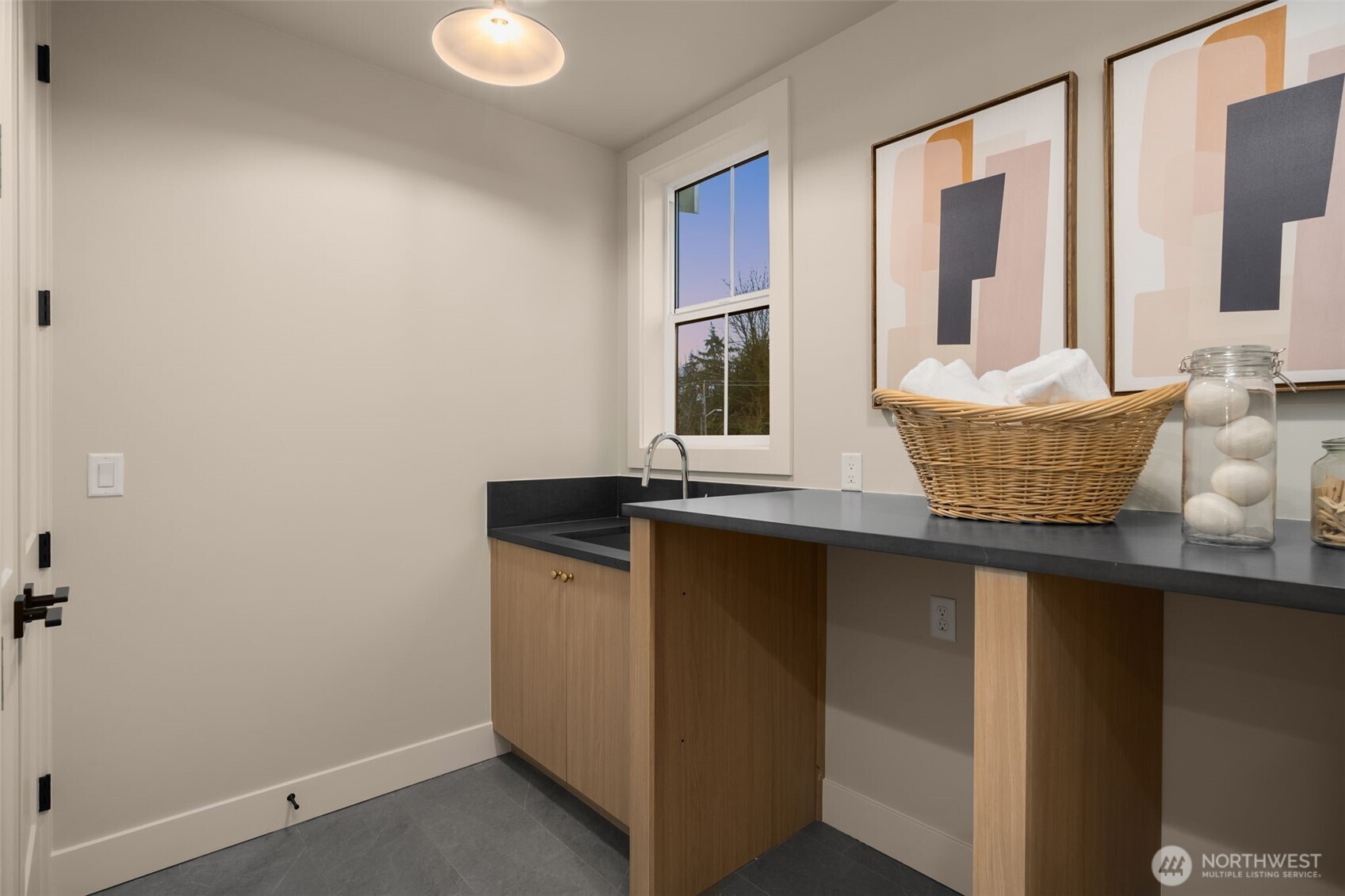 Spacious laundry room with sink.