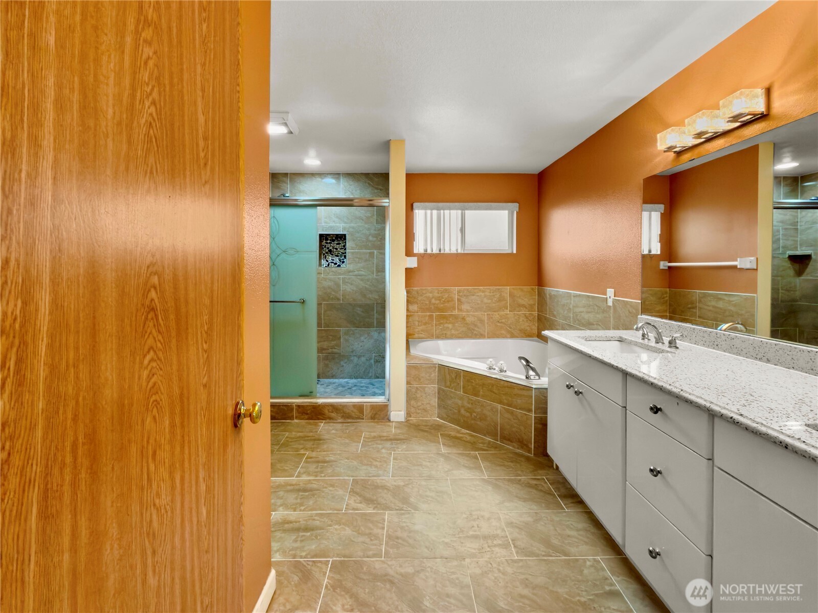 Primary bath with dual sink vanity for everyday convenience and a soaking tub perfect for relaxation.