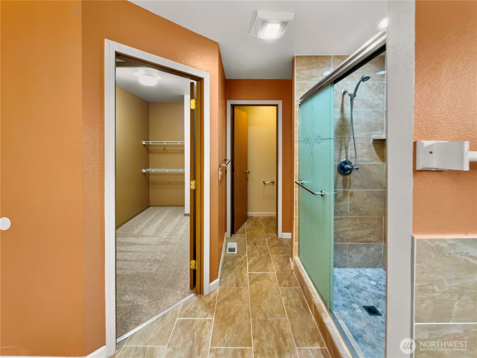 The walk-in primary closet offers ample storage space.