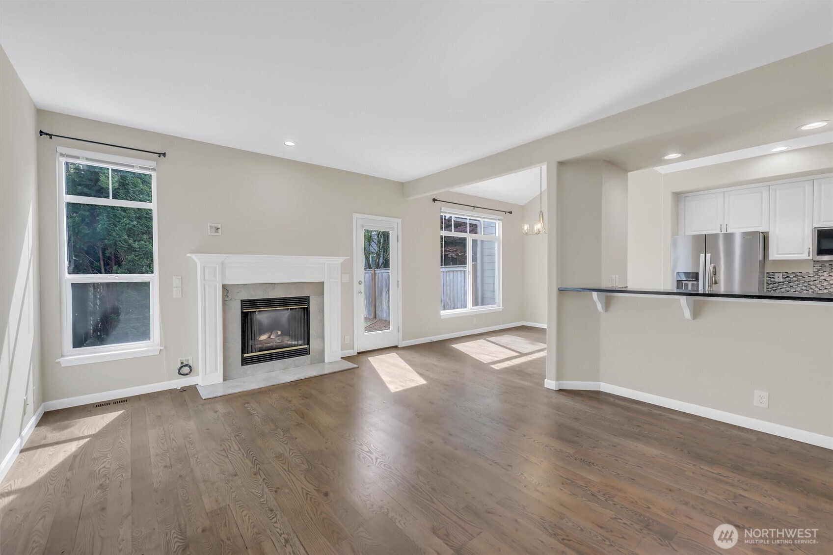 Living room has lots of light and door to backyard.