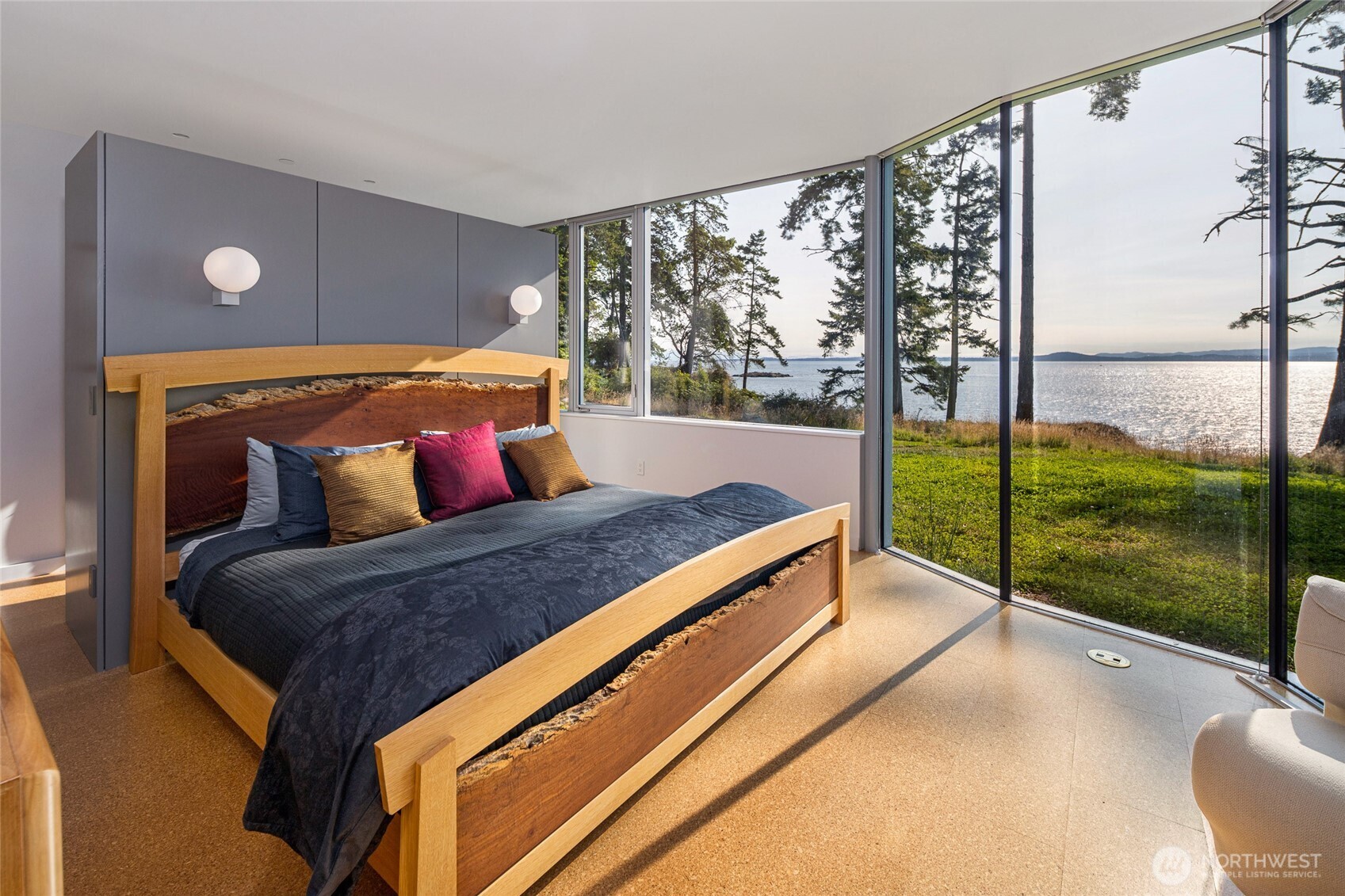 Another tranquil bedroom retreat framed by sweeping views of the water and surrounding landscape—offering the perfect place to relax after a day exploring the islands.