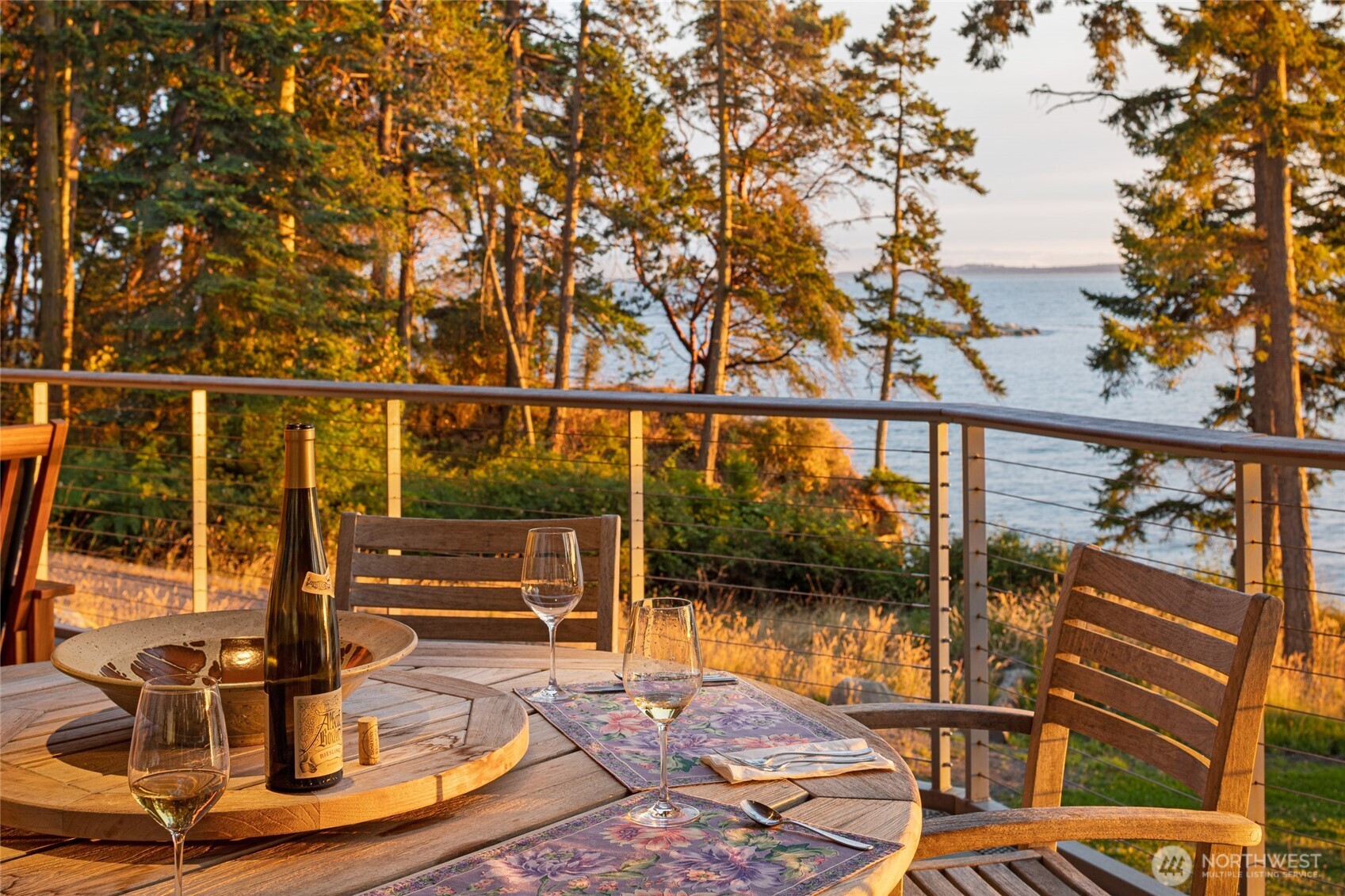 Enjoy outdoor dining on the expansive deck where panoramic water views, warm sunset light, and coastal breezes create an unforgettable setting for evenings on San Juan Island’s west side waterfront.