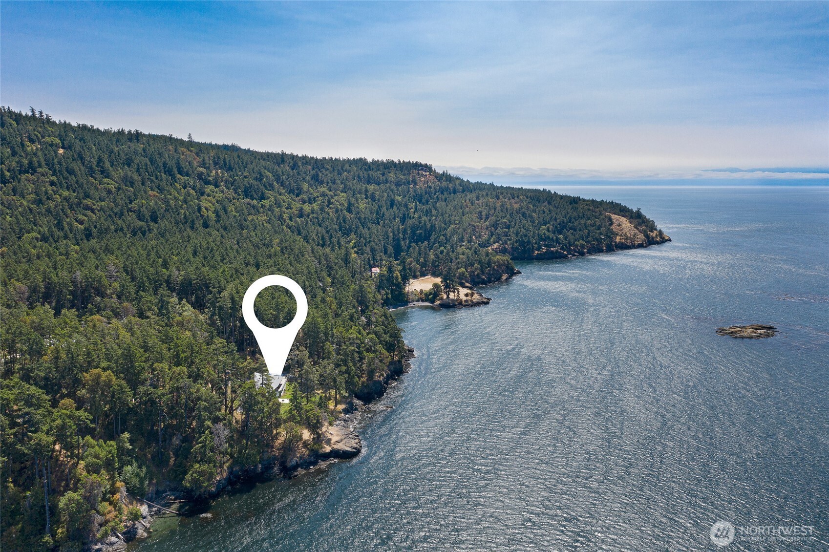 Spectacular aerial perspective highlighting the estate’s coveted west side location on San Juan Island. Positioned above the shoreline with sweeping views across Haro Strait toward the Olympic Mountains and the surrounding San Juan archipelago.