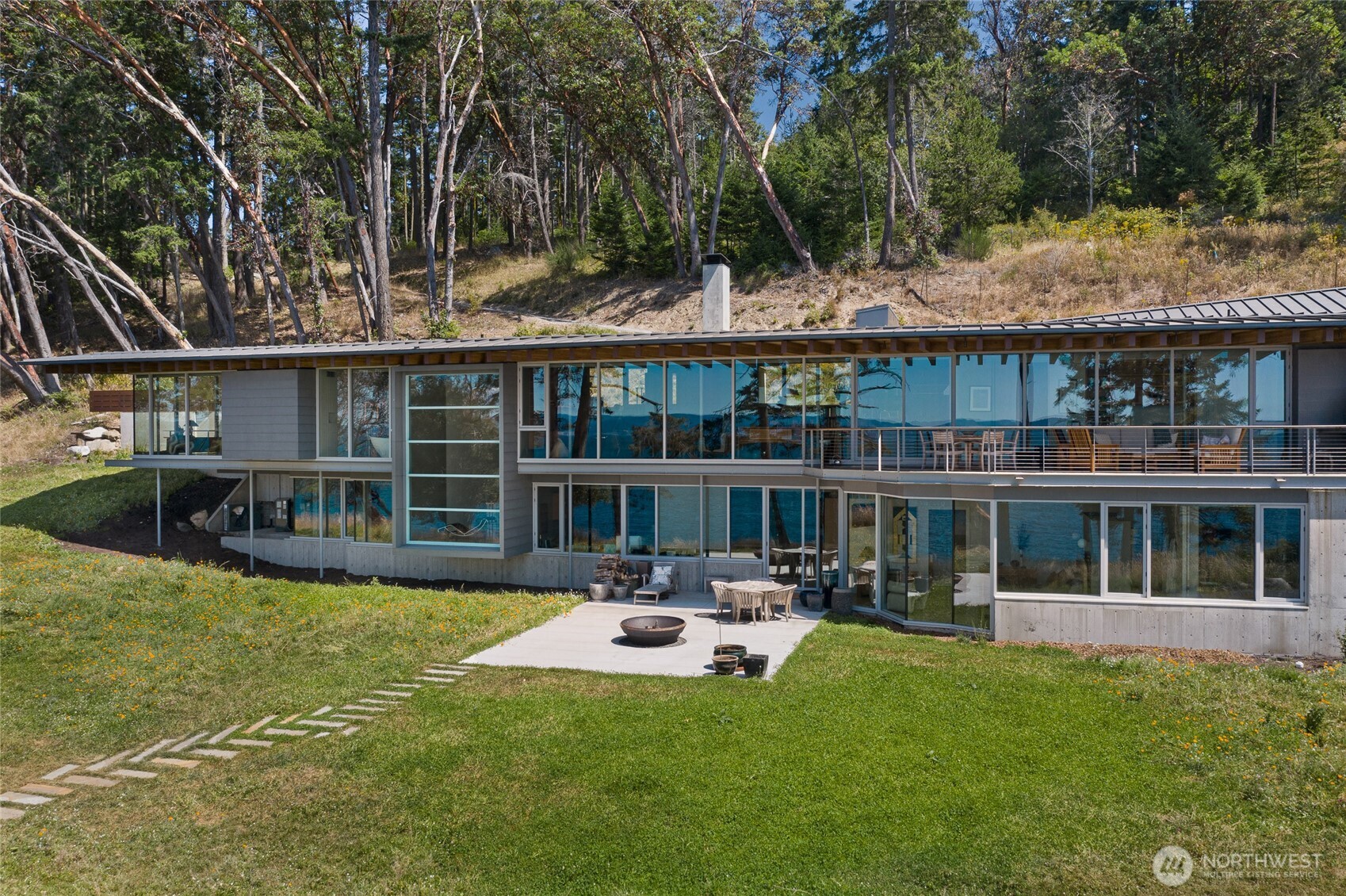 A striking example of modern Pacific Northwest architecture, the residence sits just above the shoreline, designed to capture panoramic Haro Strait views and spectacular San Juan Island sunsets.