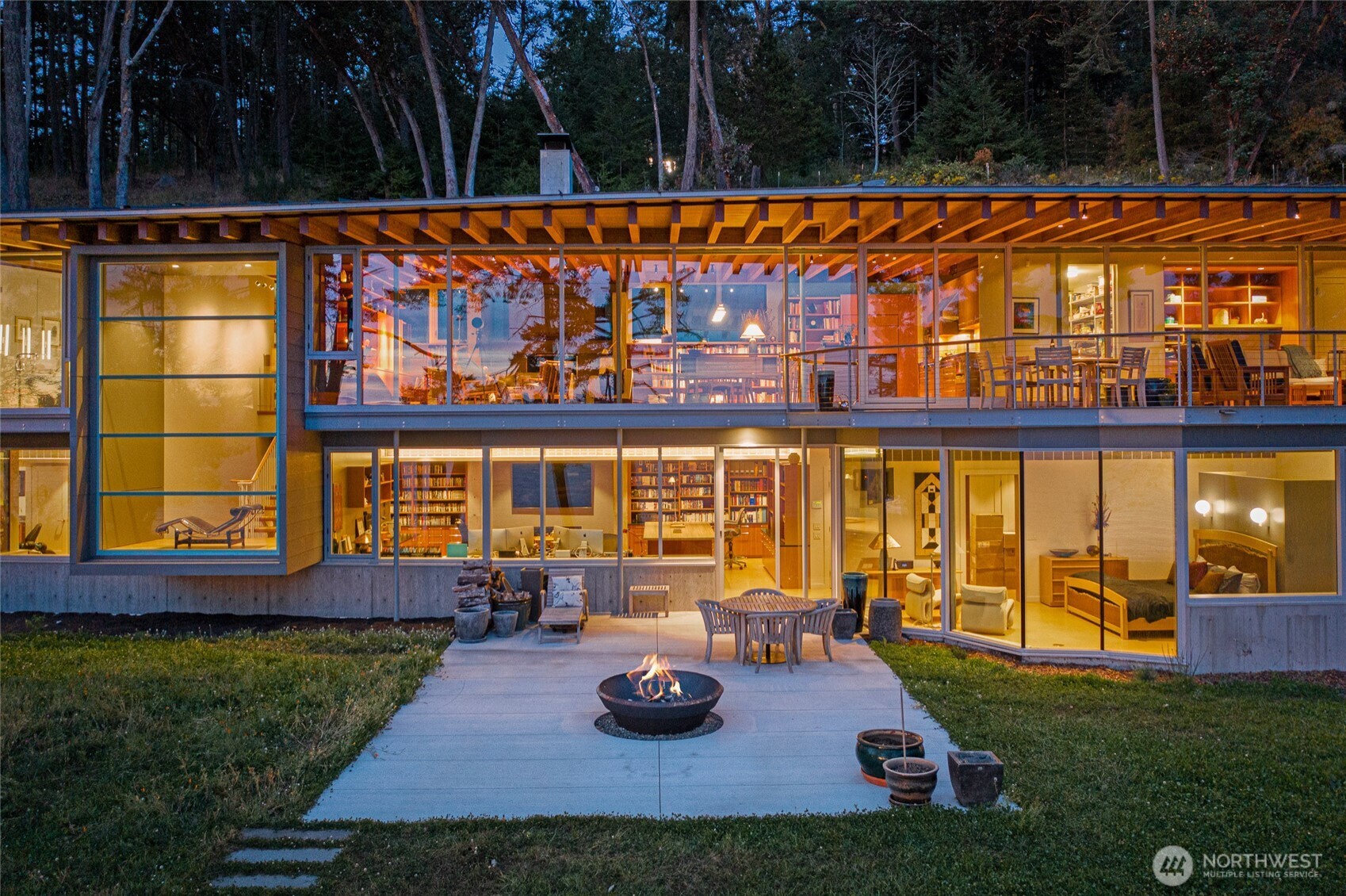 Evening light reveals the home’s dramatic glass walls and refined interiors, capturing the essence of luxury waterfront living on San Juan Island with uninterrupted views of Haro Strait and the Olympic Mountains.