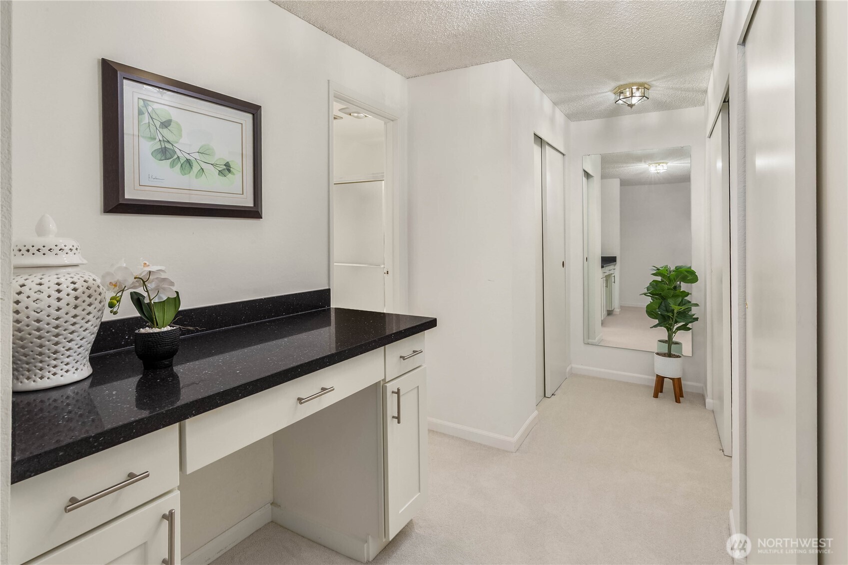 Vanity and closets in primary bedroom suite.